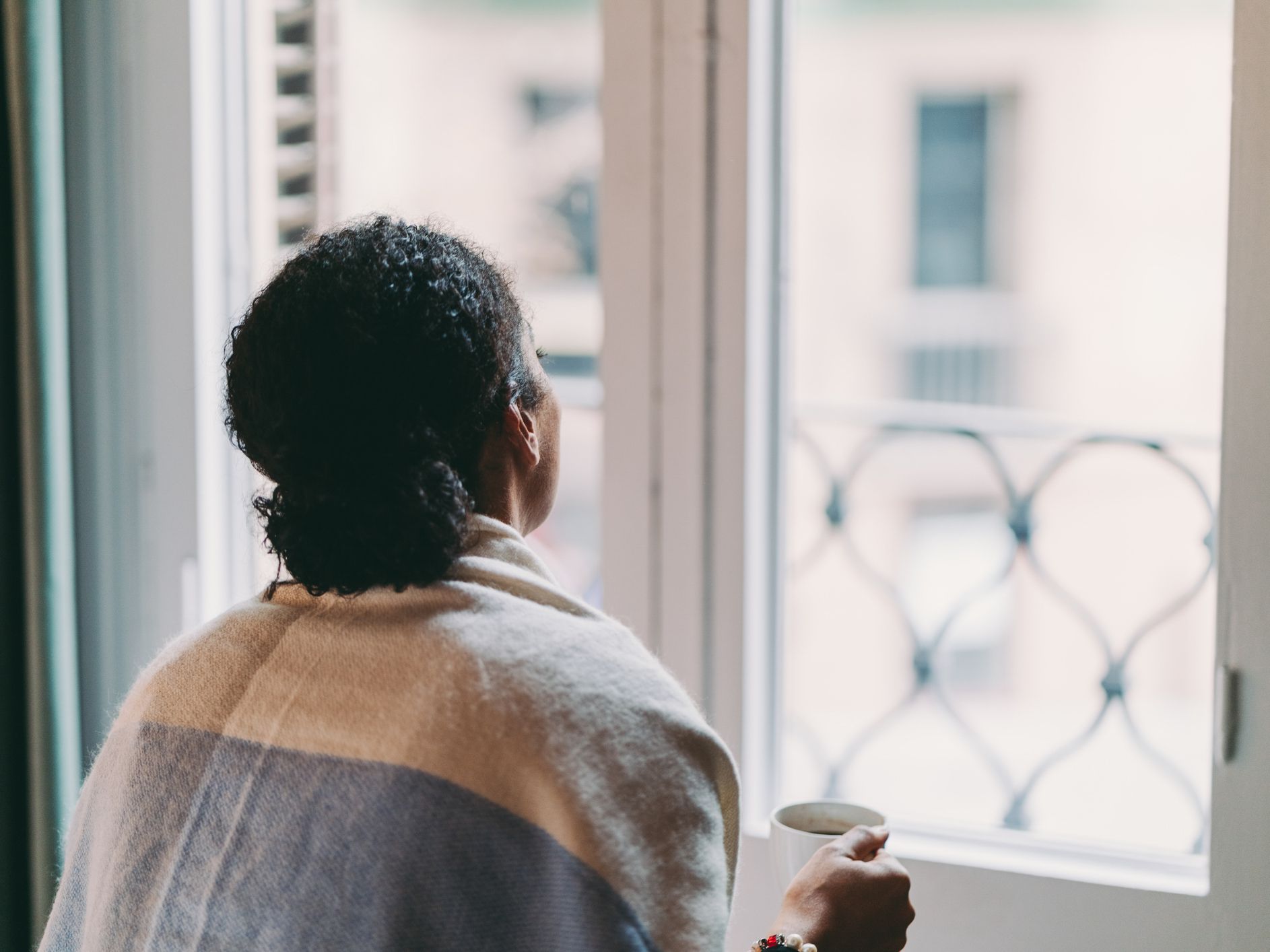 Woman in quarantine staying home, drinking coffee feeling depressed
