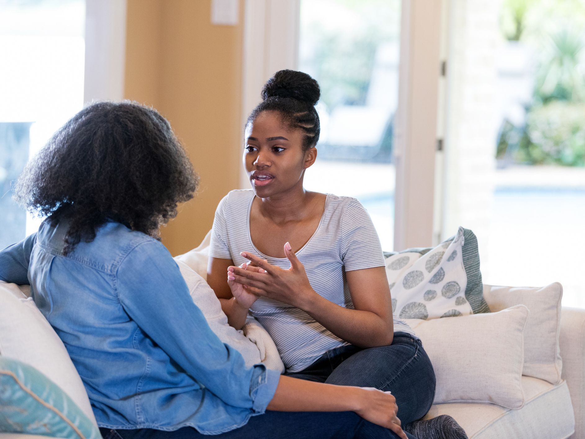 Serious young woman talks with her mom about an issue. The woman is seeking her mom's advice.