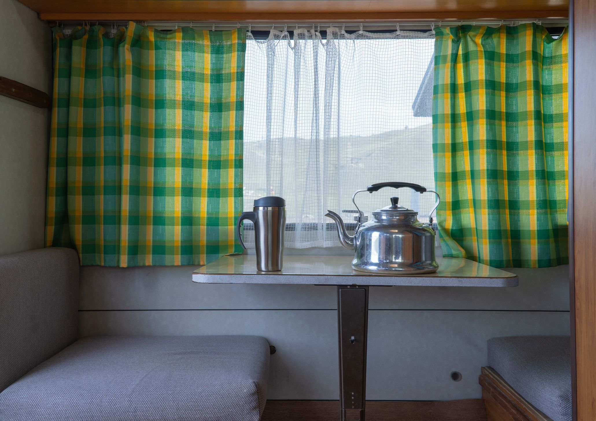 seat and table inside the trailer. camper van interior. caravan trailer of large size, equipped with all necessary household appliances to ensure the comfort of the traveler