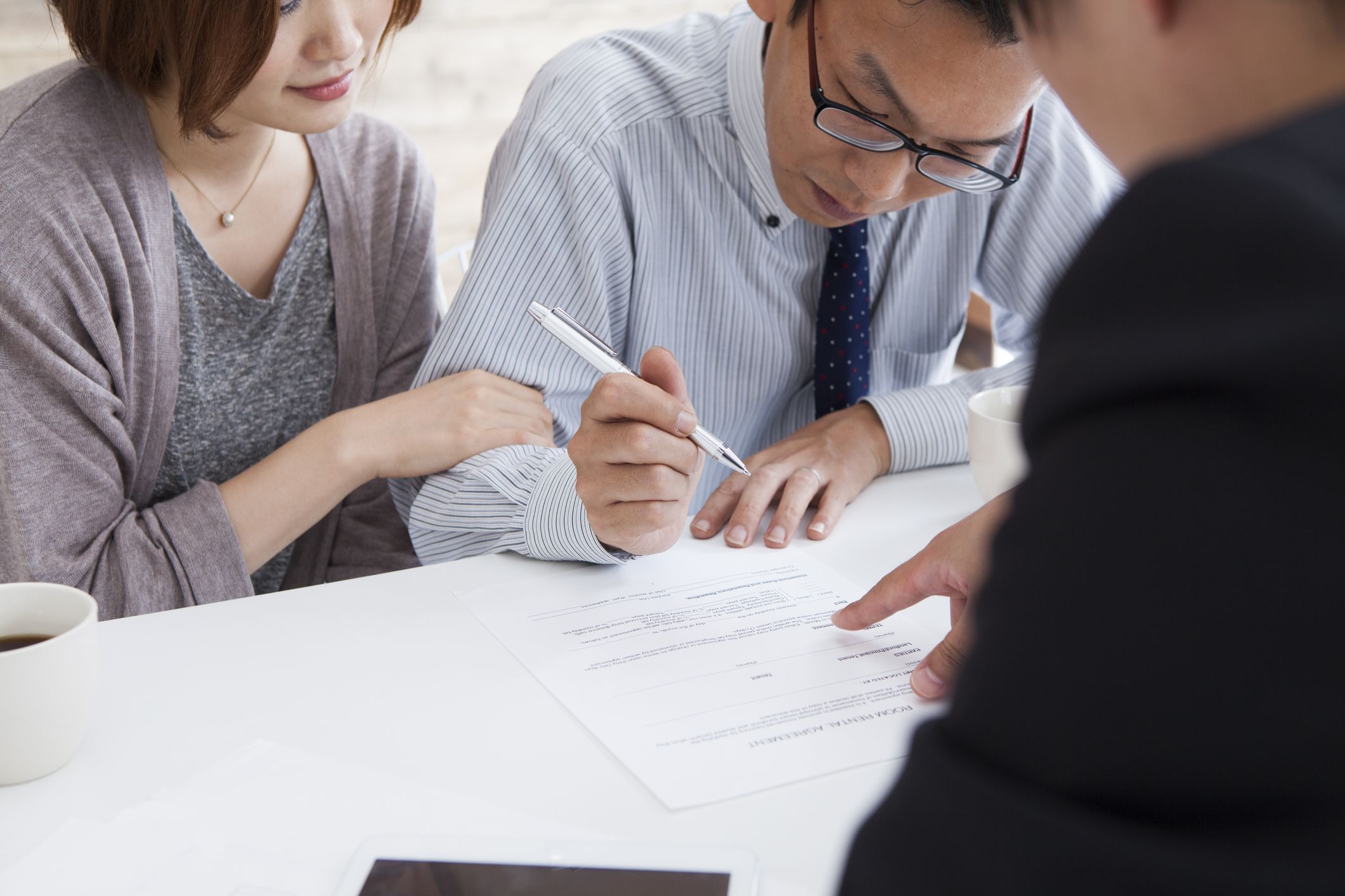 Client signing a real estate contract in real estate agency