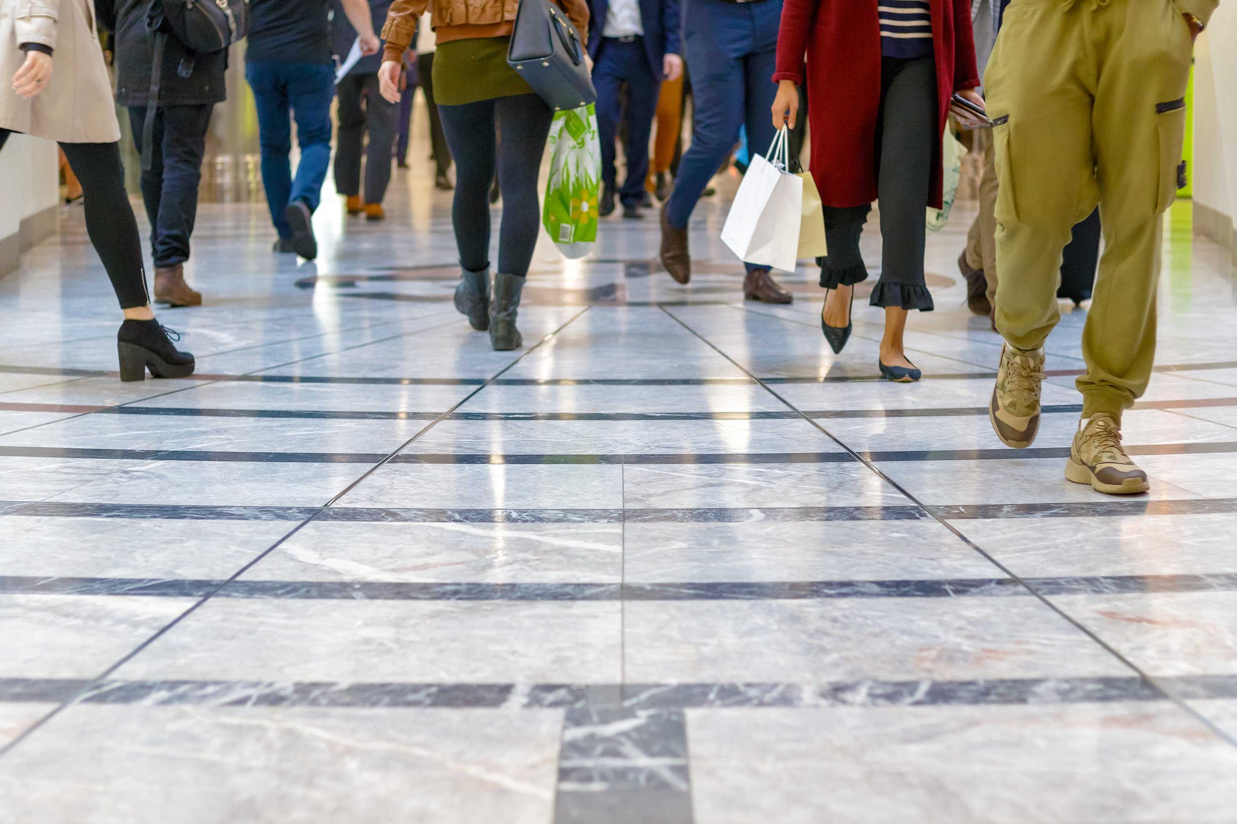 Closeup of feet walking in a busy store