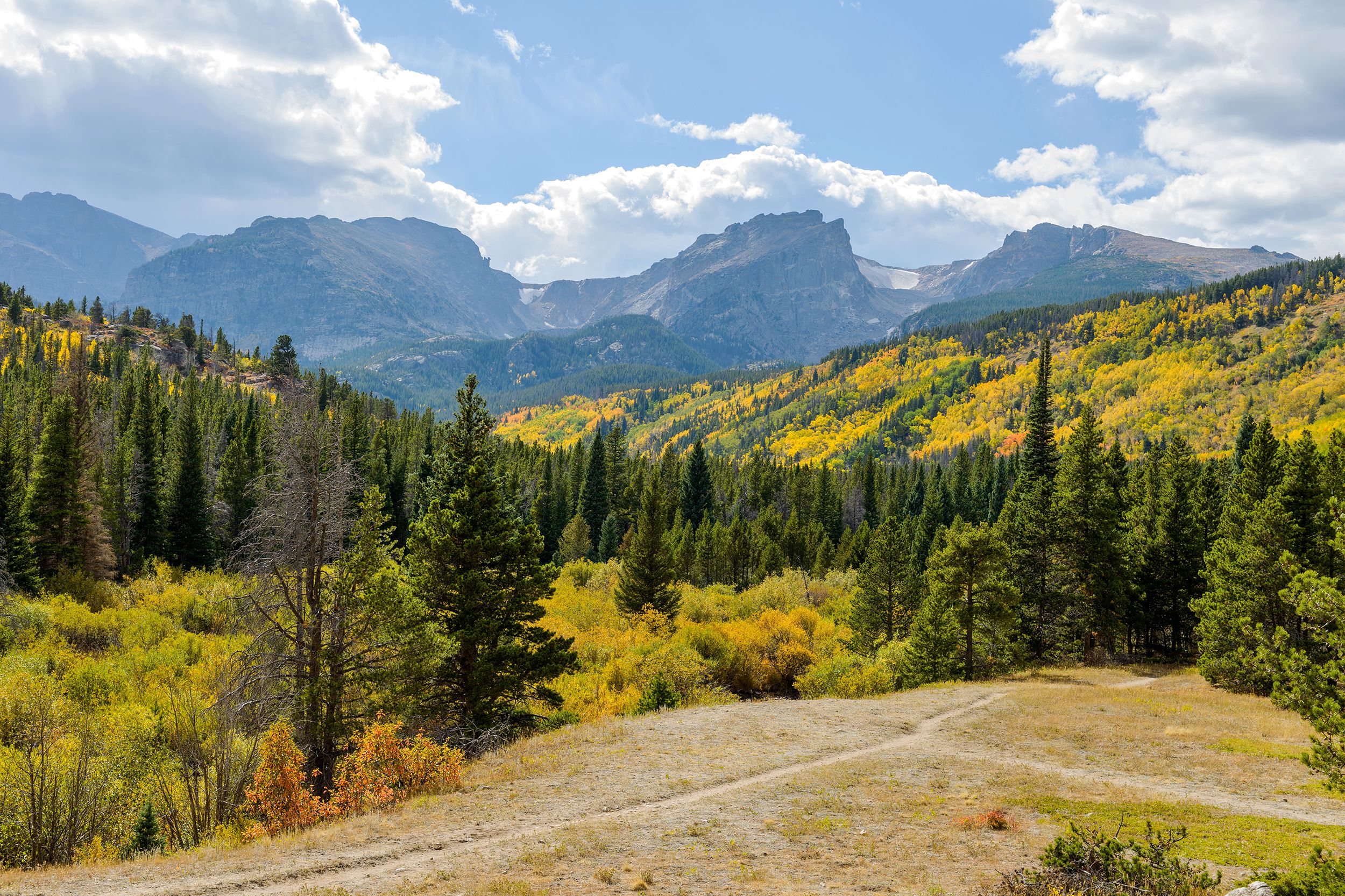 Beautiful sunny day in Estes Park, Colorado with dark mountains in background