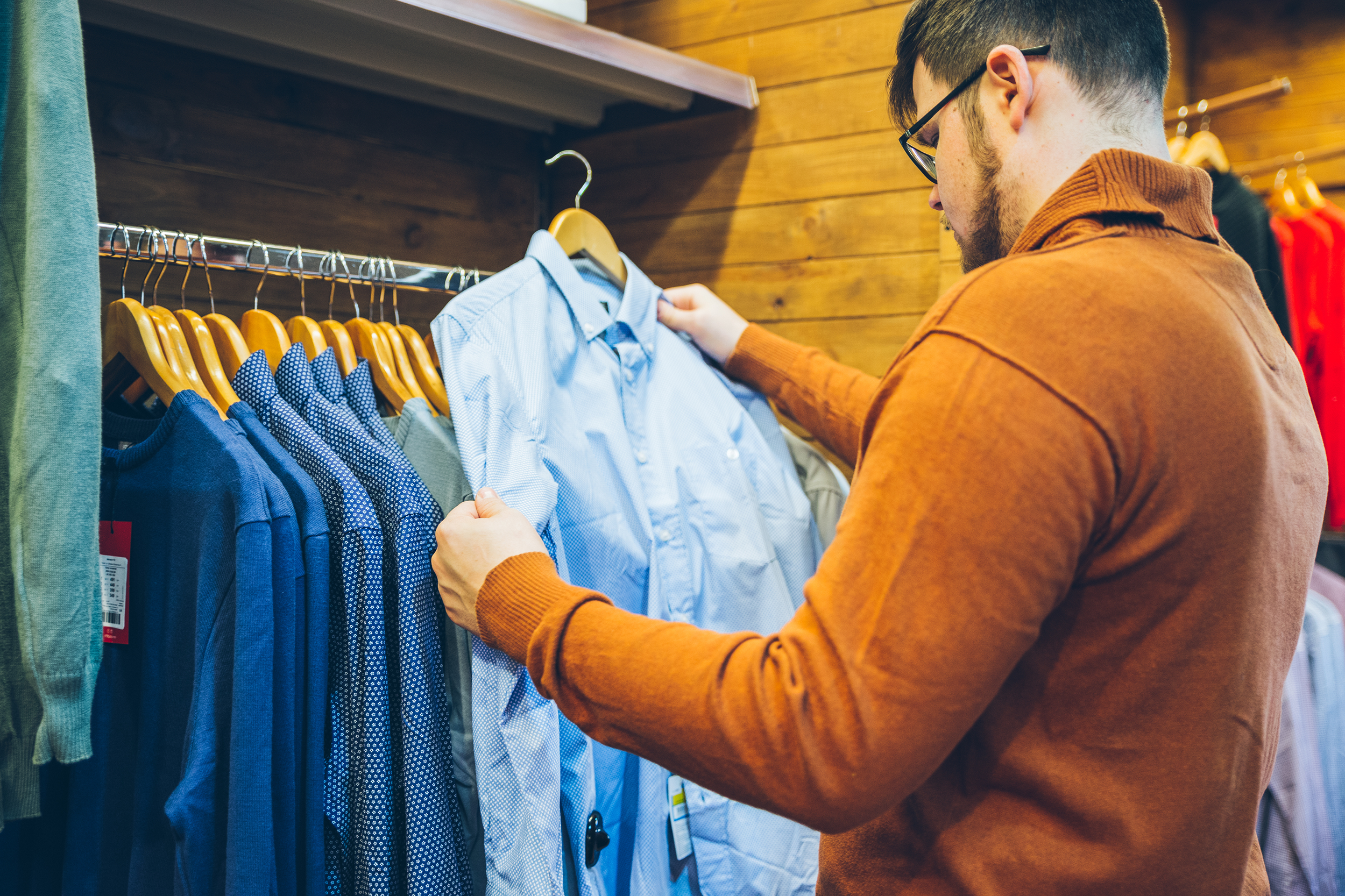 Man inspecting a shirt at a store