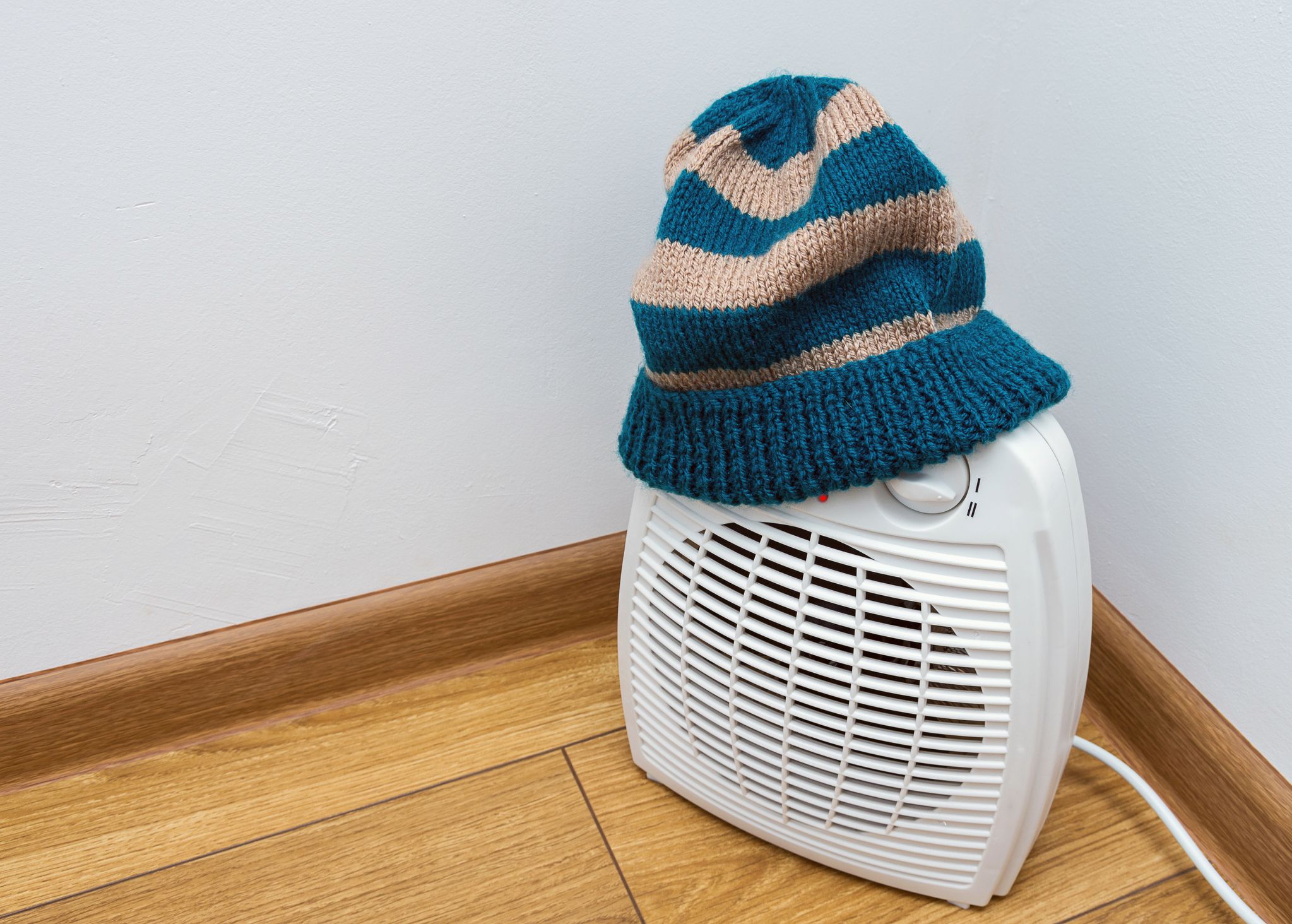 space heater with a warm knit hat at home.