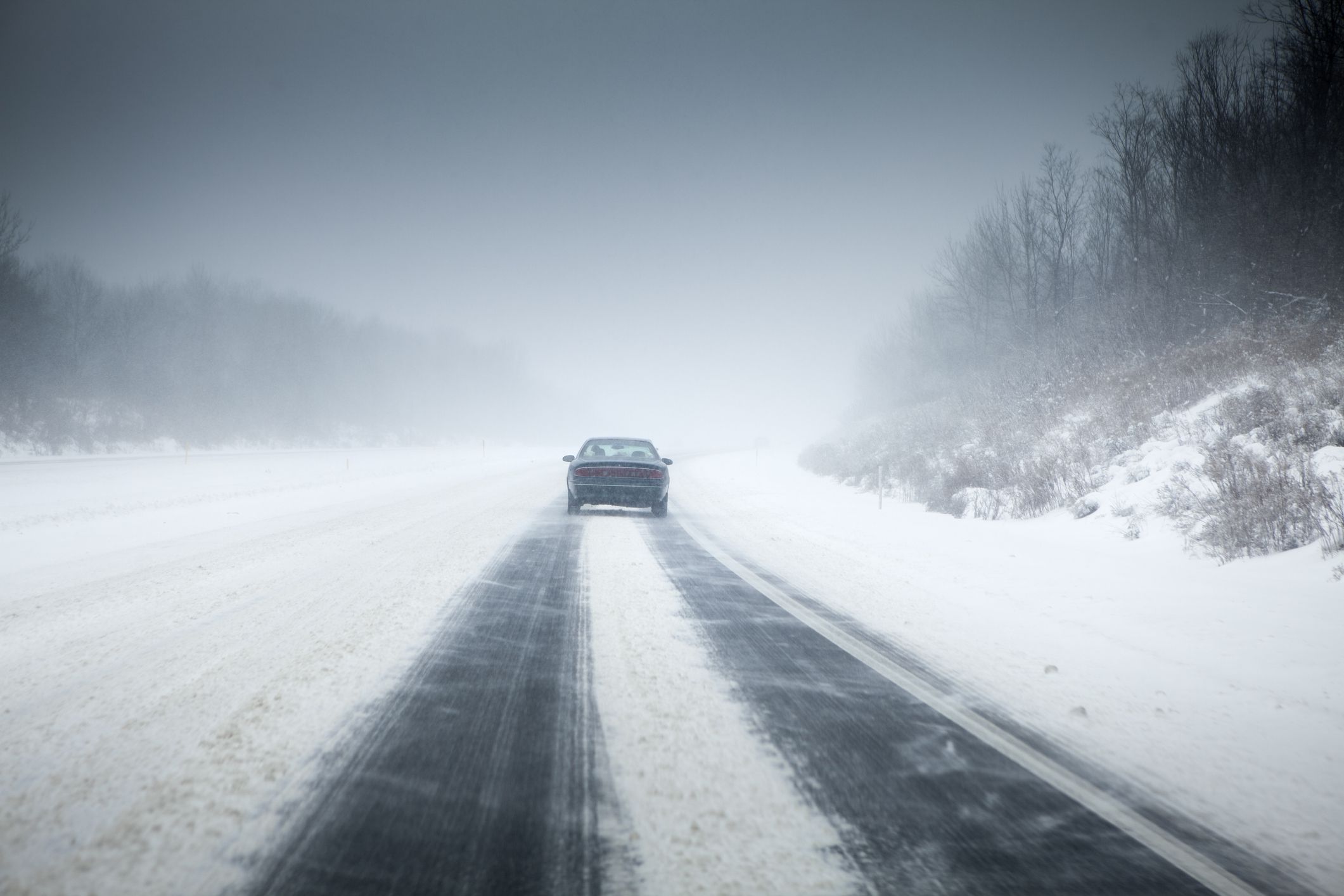 Freeway blizzard and slippery frozen road driving conditions