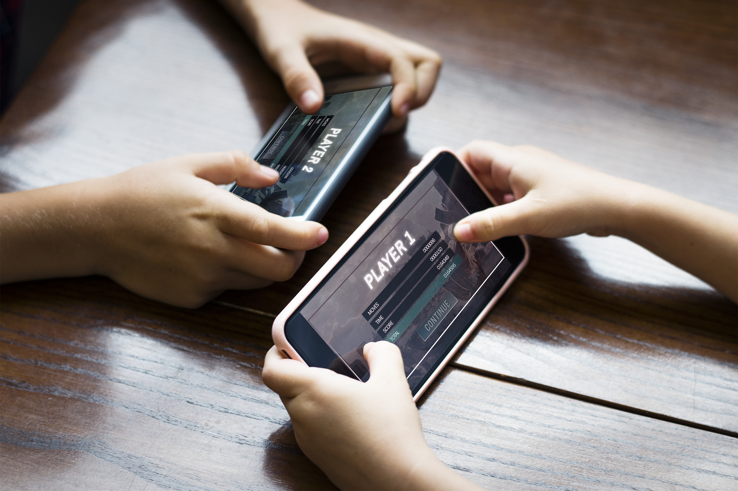 Kids playing video games on phones