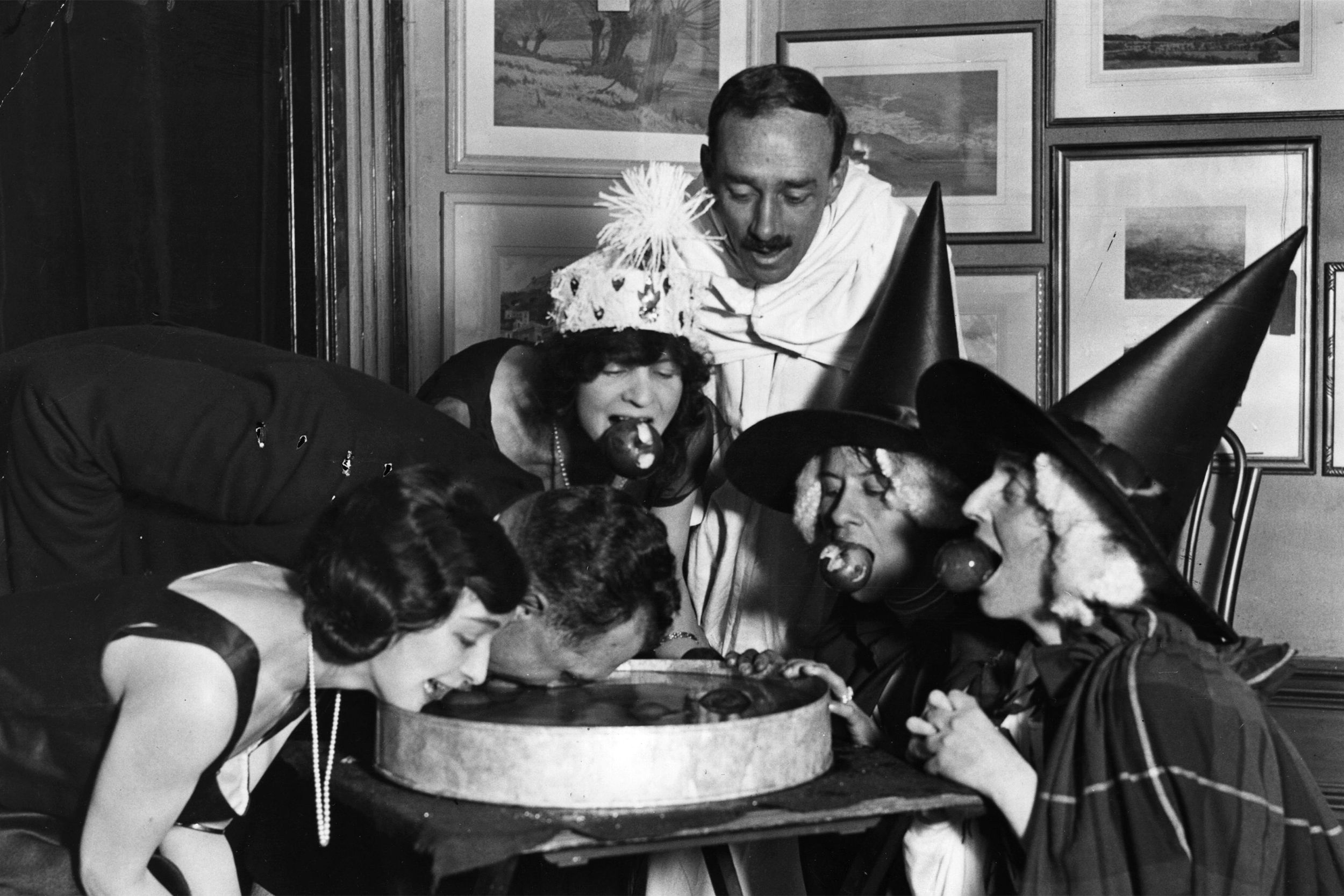 An apple bobbing game at a Halloween fancy-dress party.