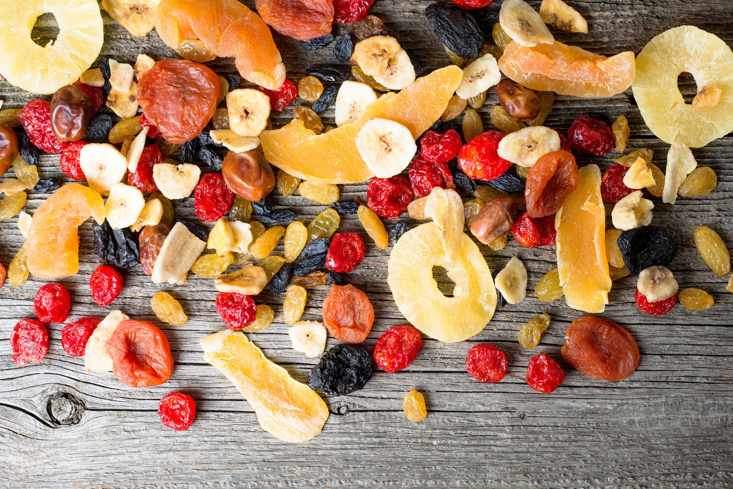 mix of dried and candied fruit on a wooden background
