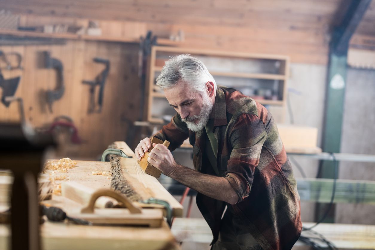 Senior Carpenter Working In His Old-Fashion Workshop
