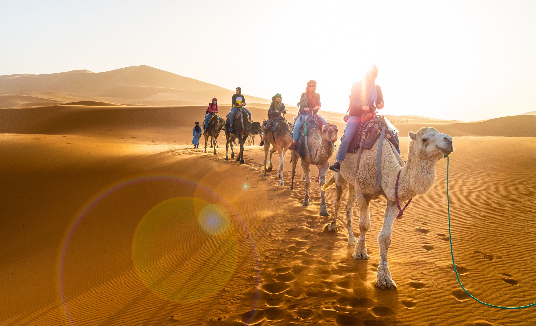 Merzouga, Morocco - May 02, 2019: Caravan walking in Merzouga Sahara desert on Morocco