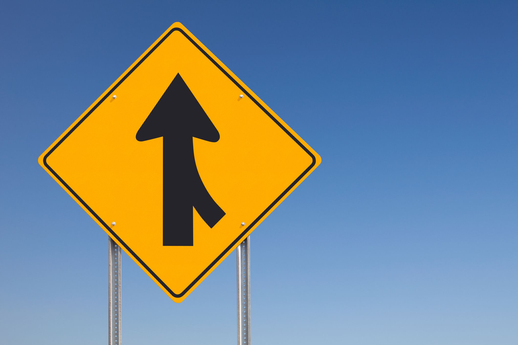 An informational traffic sign post over a clear blue sky. Photographed with a Canon 5D MarkII and