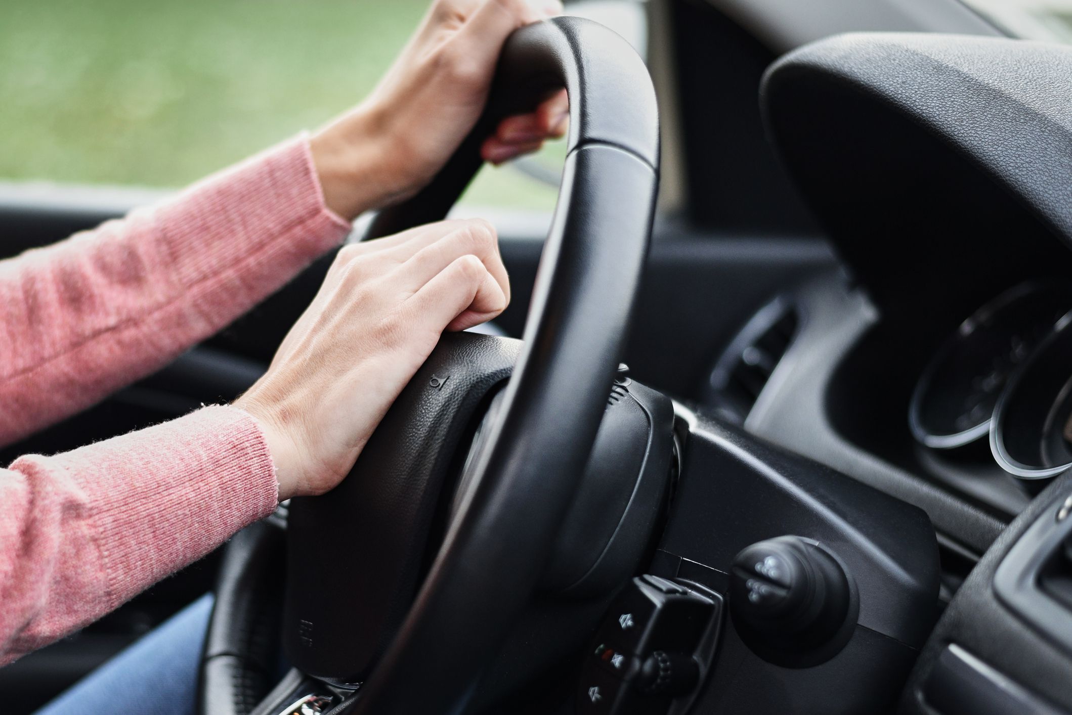 Female hand pressed horn button while driving the car