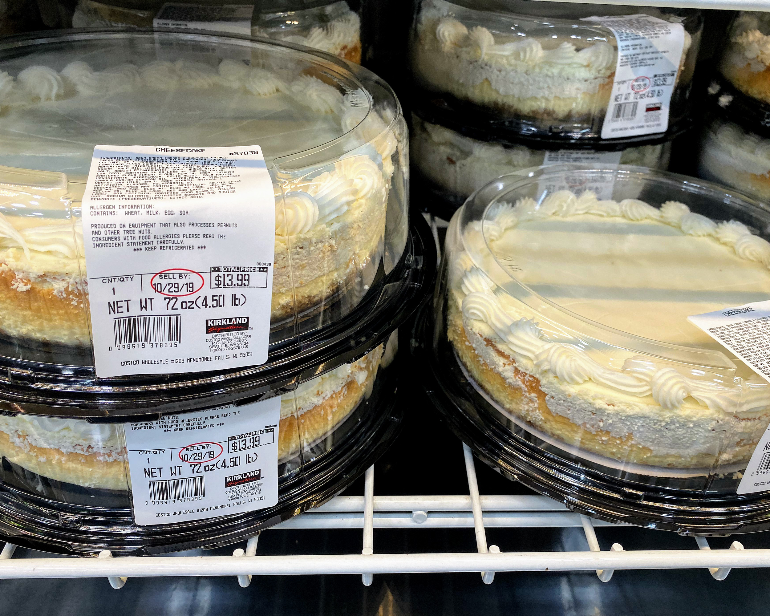 Closeup of stacked Kirkland Cheesecakes at a Costco in a refrigerator