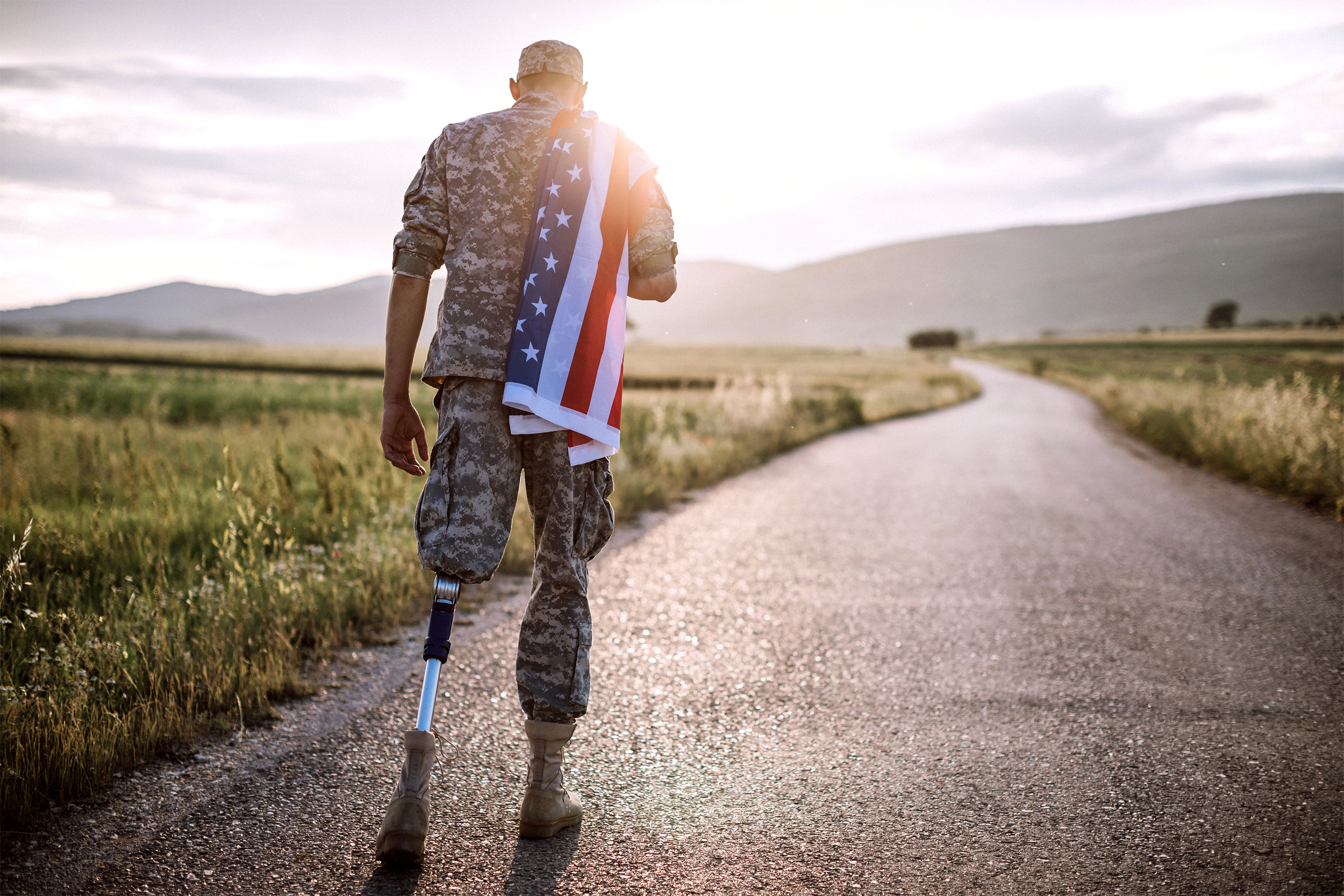 Disabled veteran walking with American flag