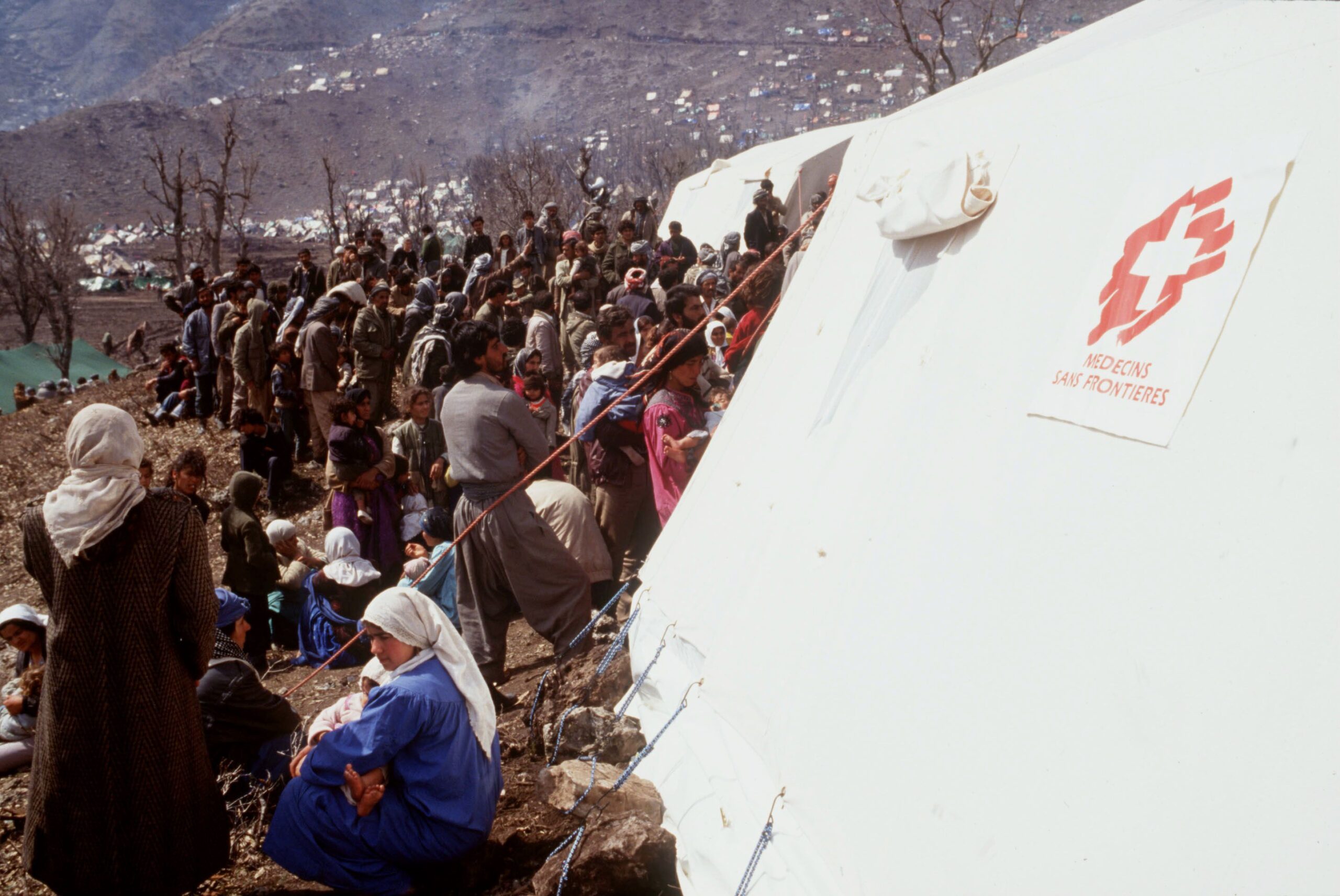People wait in front of the Doctors Without Borders tents