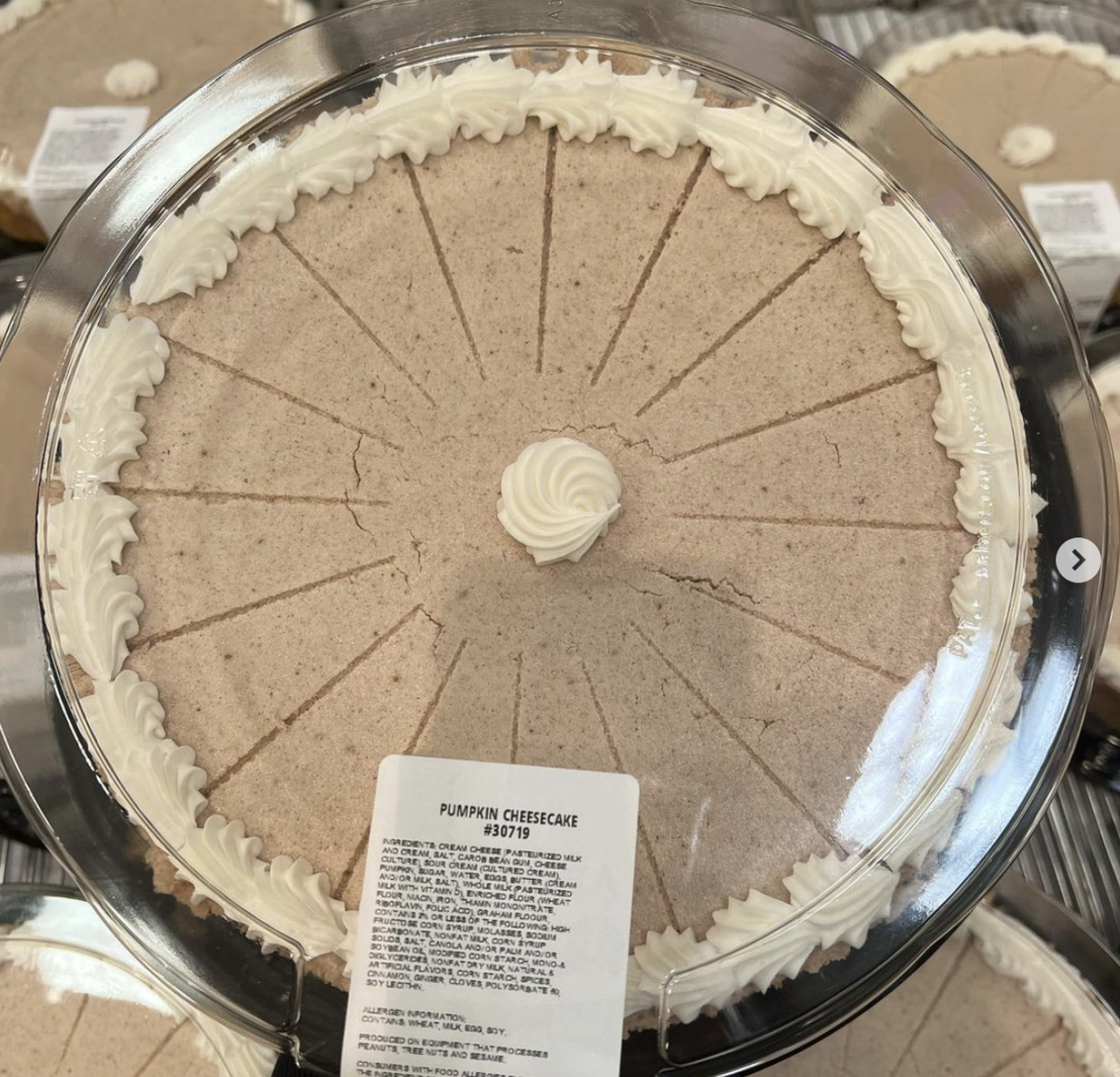Kirkland Pumpkin Cheesecake on top of a pile of others at a Costco