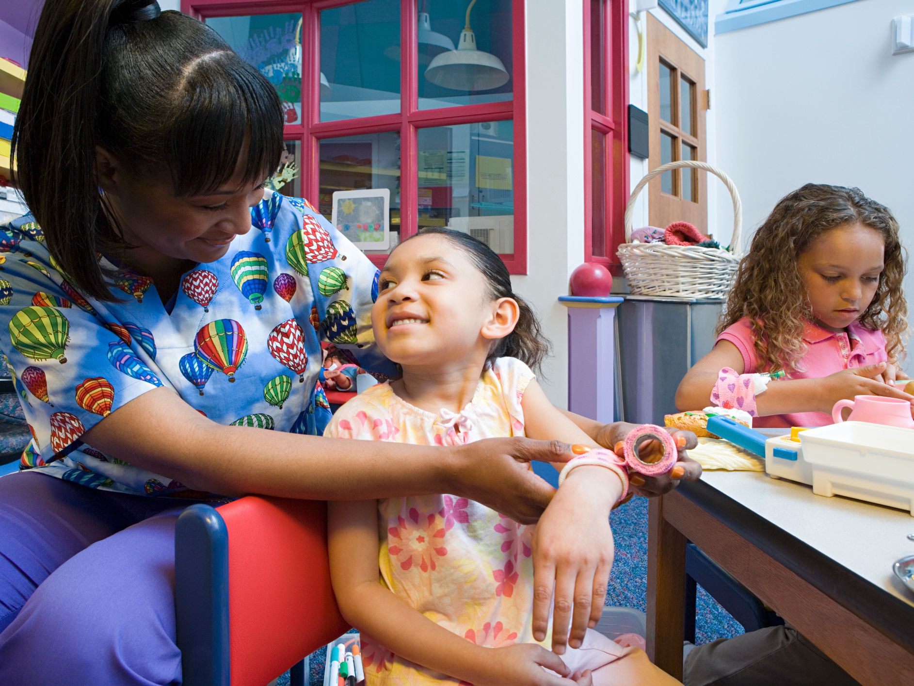 Nurse bandaging girls arm