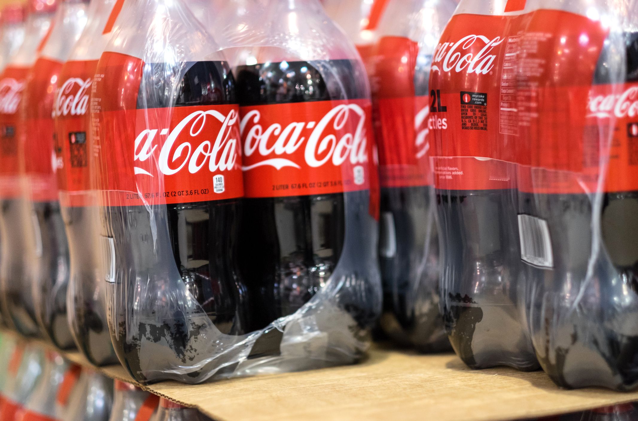 Closeup of a row of 2 liter plastic bottles of Coca Cola in a warehouse near downtown Miami