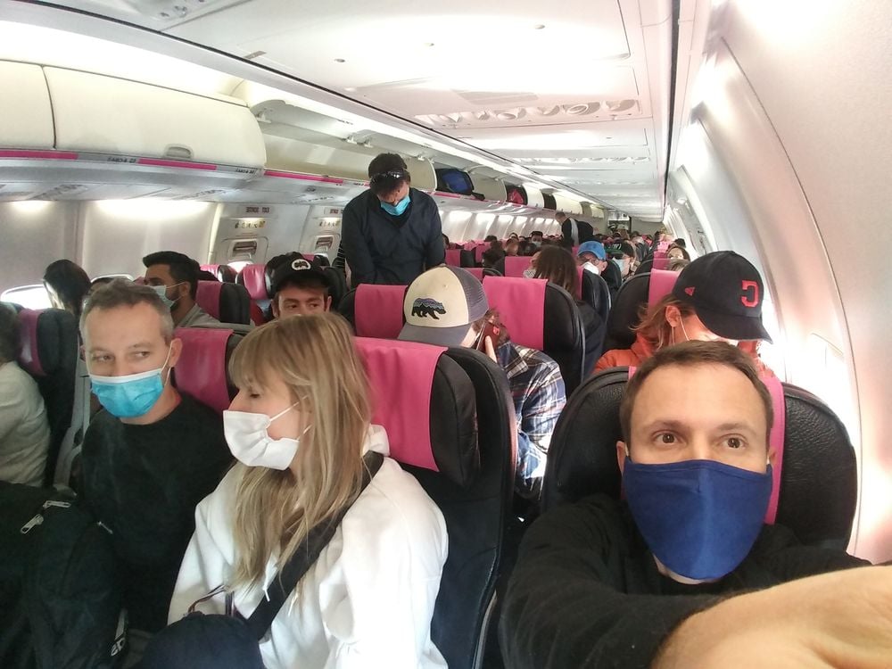Passengers with masks inside an airplane