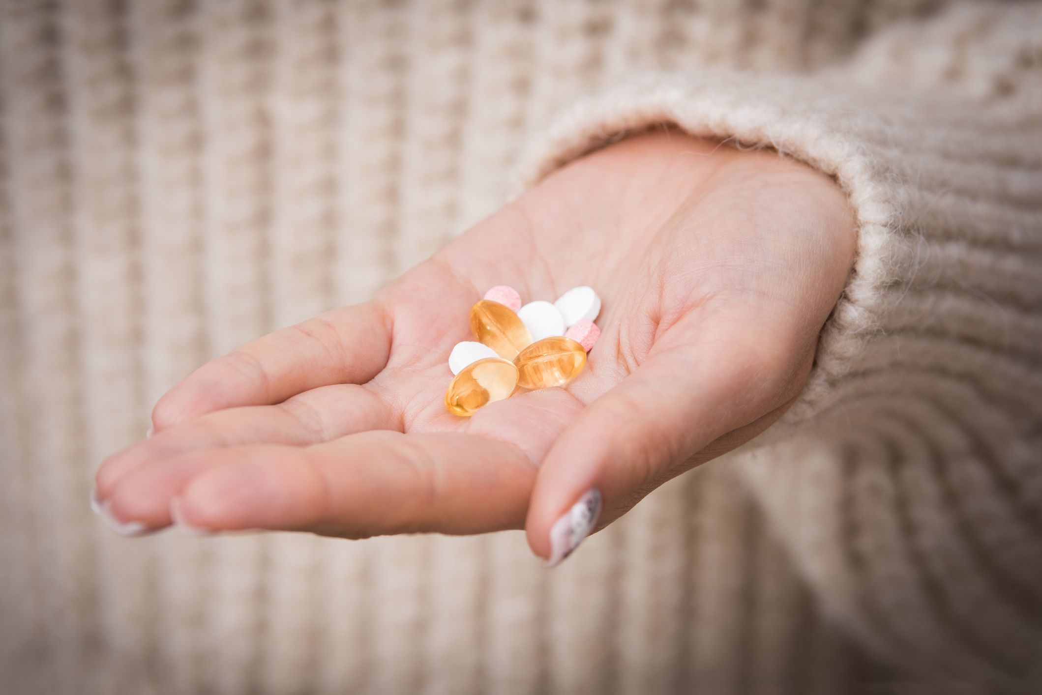 Woman hand with vitamins and medication. Taking vitamin and supplement. B12, D3, selenium. High quality photo