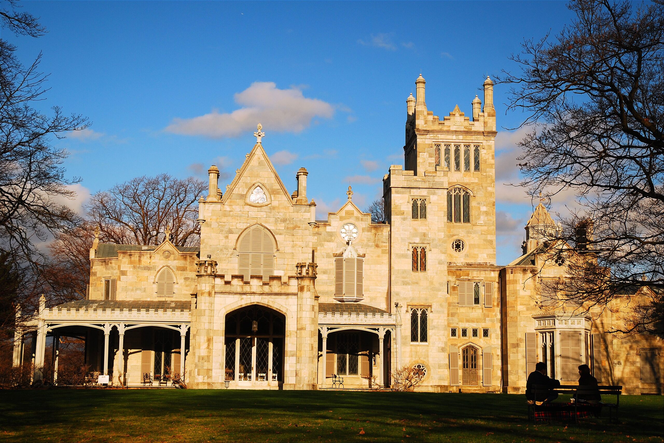 Tarrytown, NY, USA April 12, 2008 A man and woman enjoy a relaxing view of Lyndhurst Castle on an early spring day in Tarrytown, New York