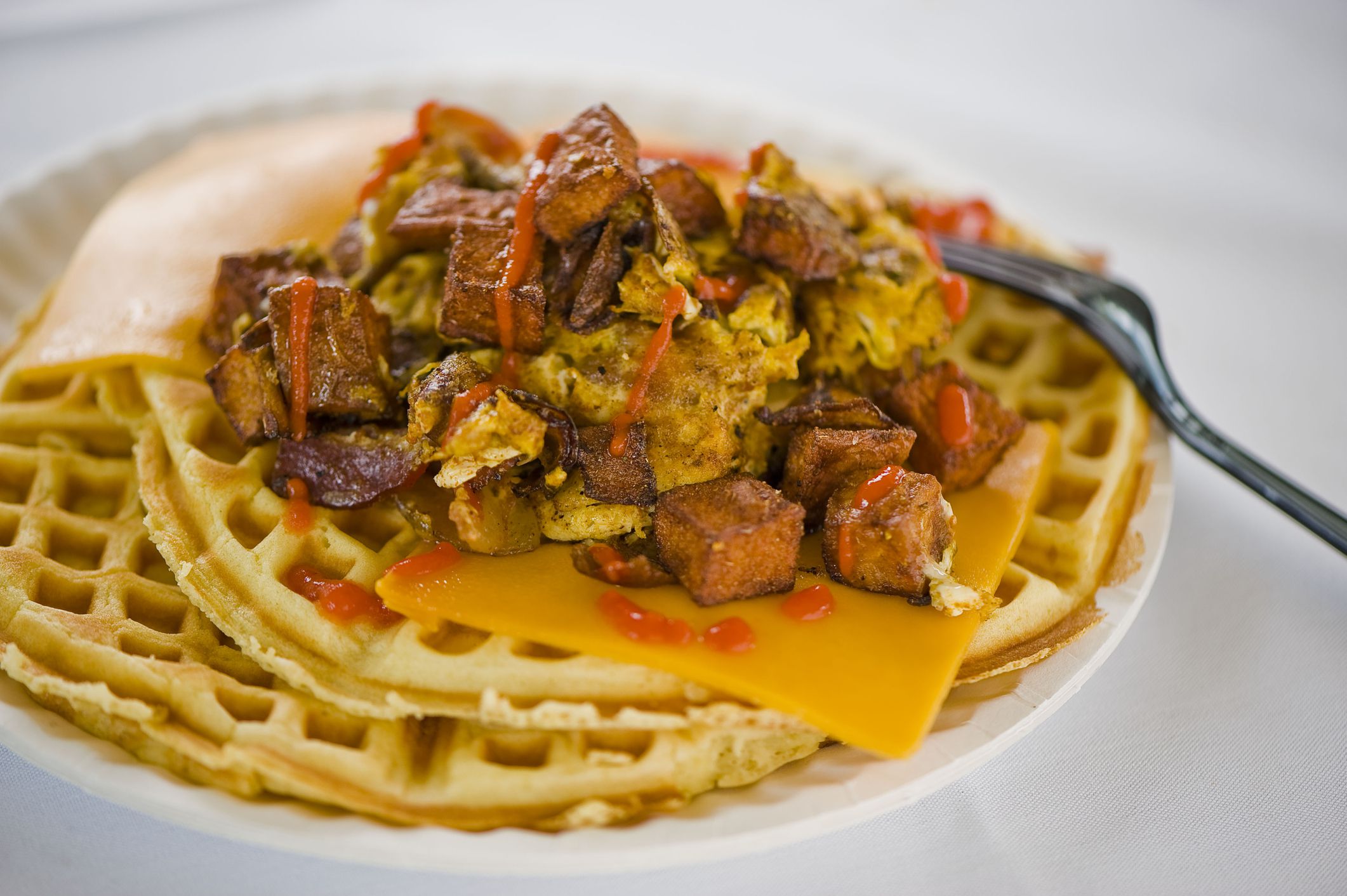Chicken and waffles. Homemade Waffles w/ crispy chicken, butter & maple syrup. Classic American breakfast or brunch favorite. Made from scratch waffles w/ chicken, butter & maple syrup.