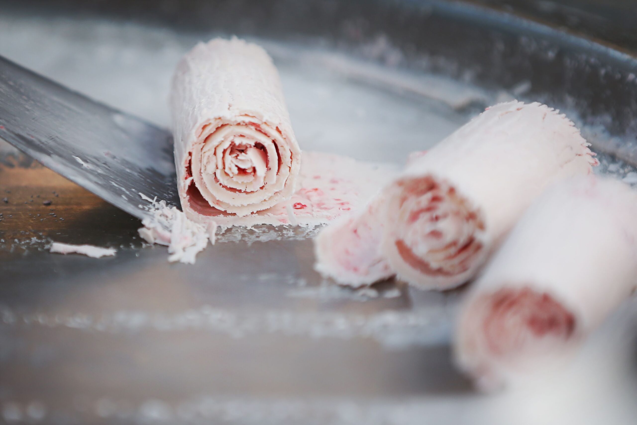 A man makes ice cream rolls