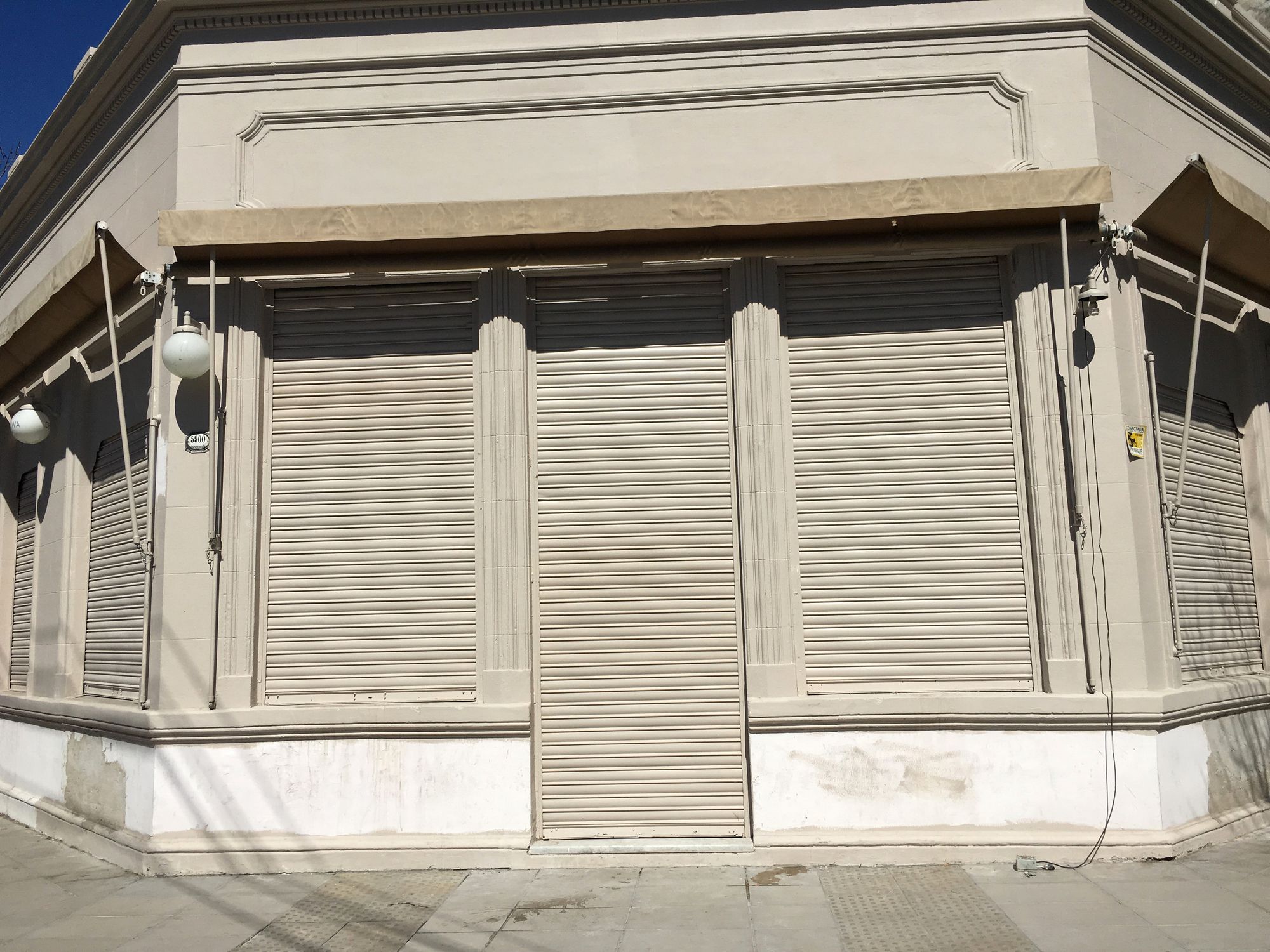 Bar establishment with its blinds still closed during the day. It is not unusual for this businesses to open late during the day since they stay opened until late hours of the night