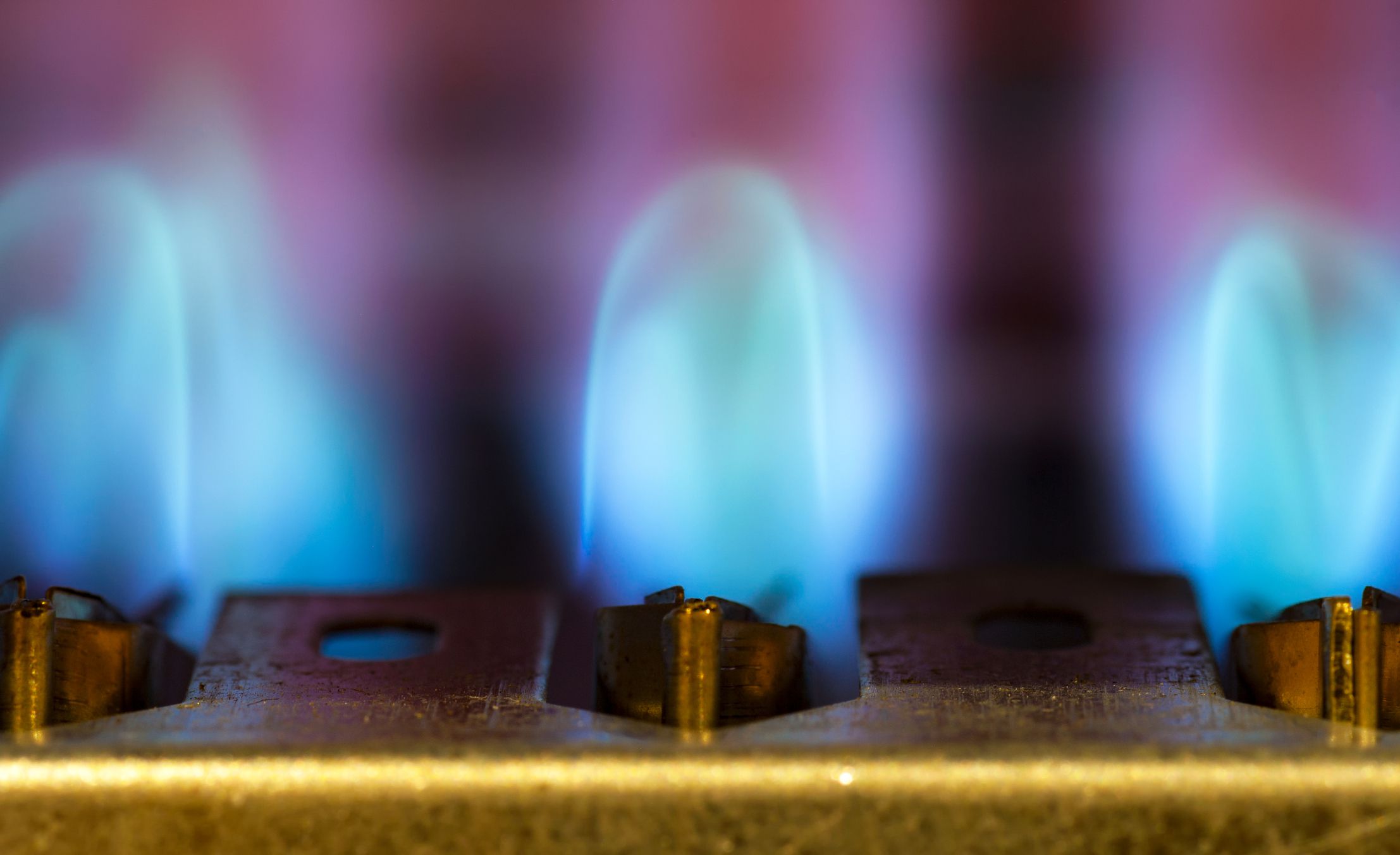 Gas burns in modern water heater. Сloseup. Selective focus.