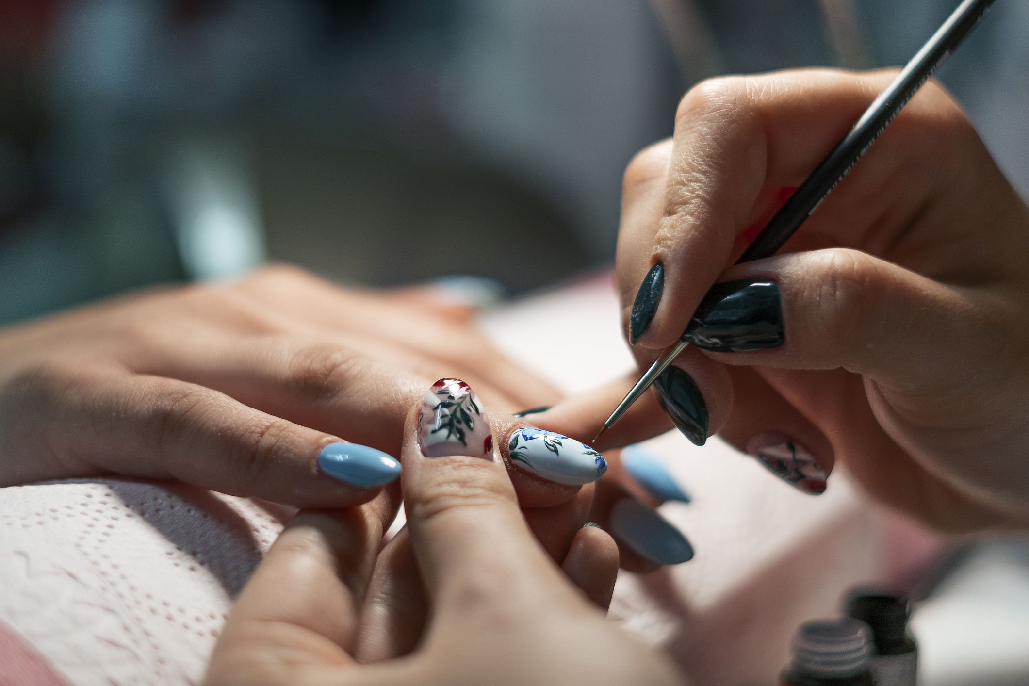 Nails care for women. Close up of beautiful female hands having manicure treatment. Nail polishing.