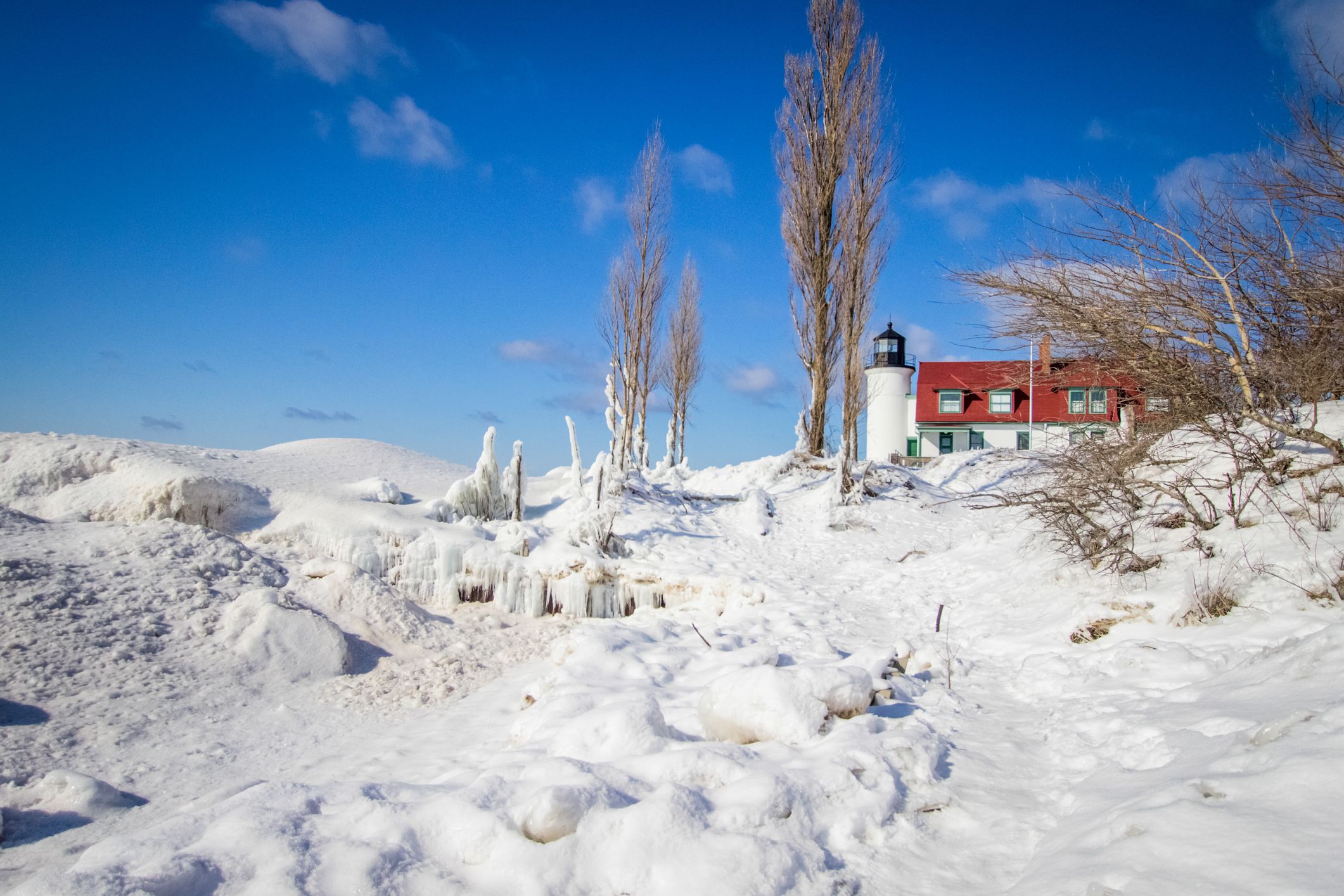 Frozen winter landscape on the coast of Lake Michigan at the Point Betise Lighthouse in the Sleeping Bear Dunes National Lakeshore.