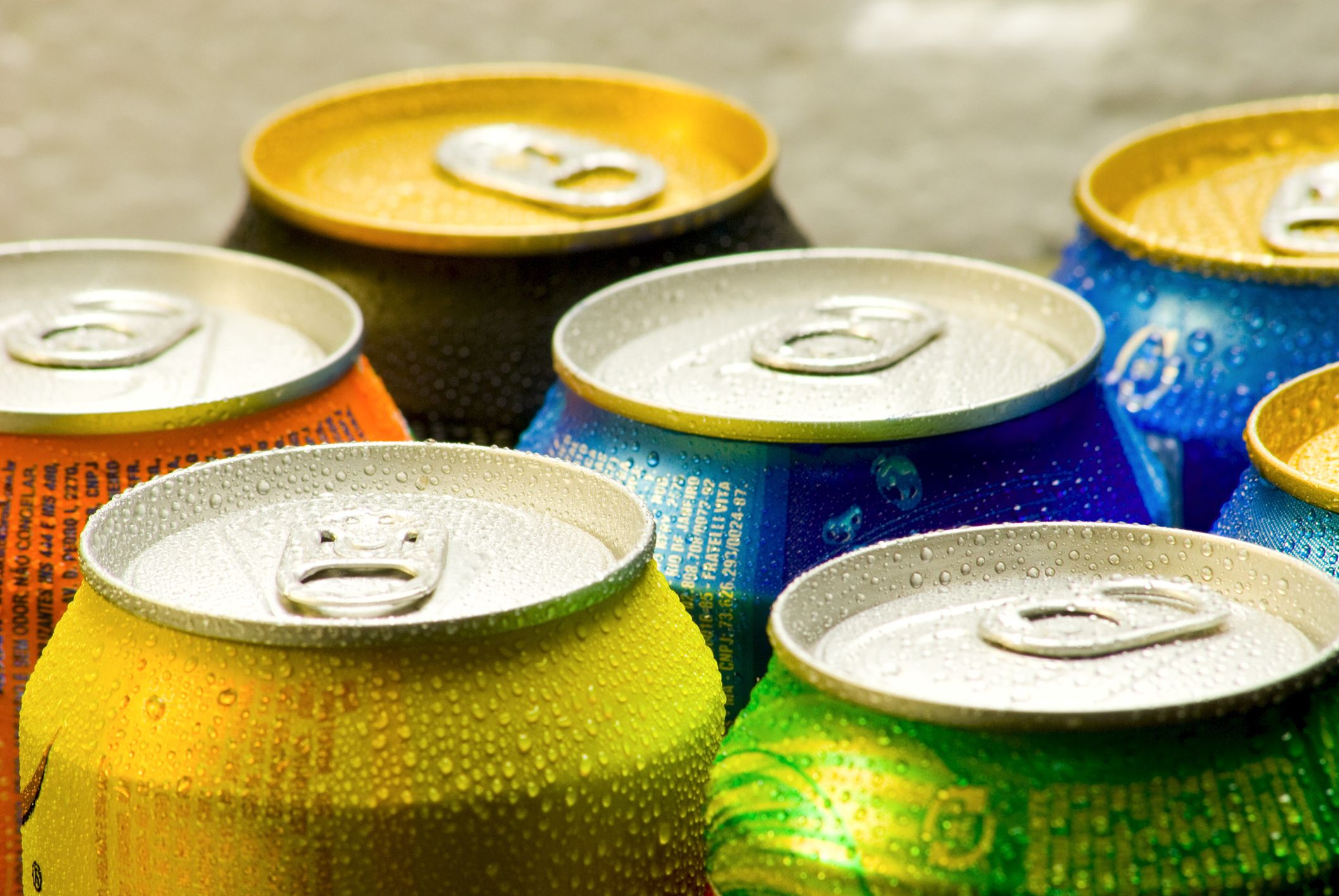 Cans of soft drink. Cooling frozen and with water drops