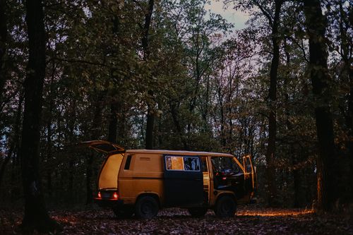 rv in the forest at dark