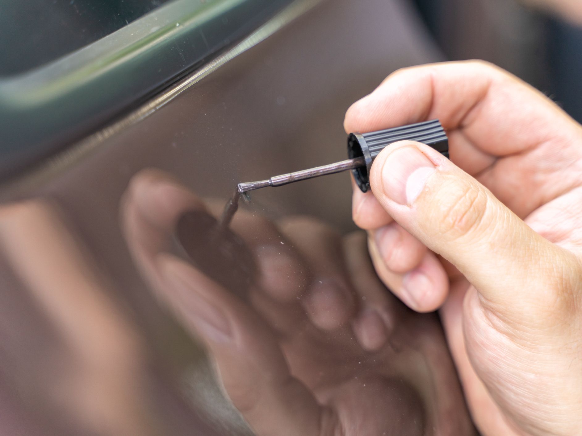 master paints a dent on a car with auto enamel
