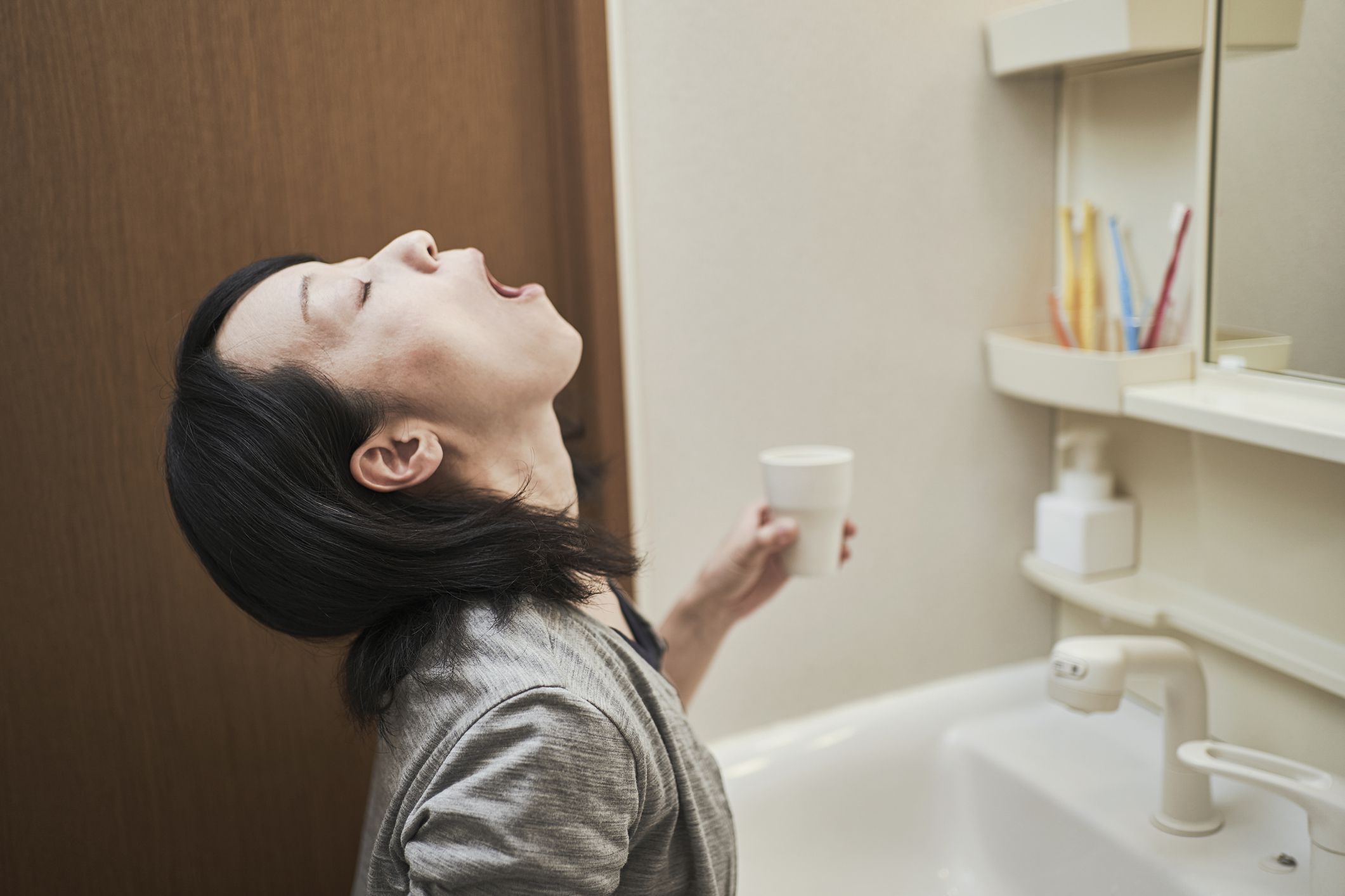 Woman gargle in the washroom