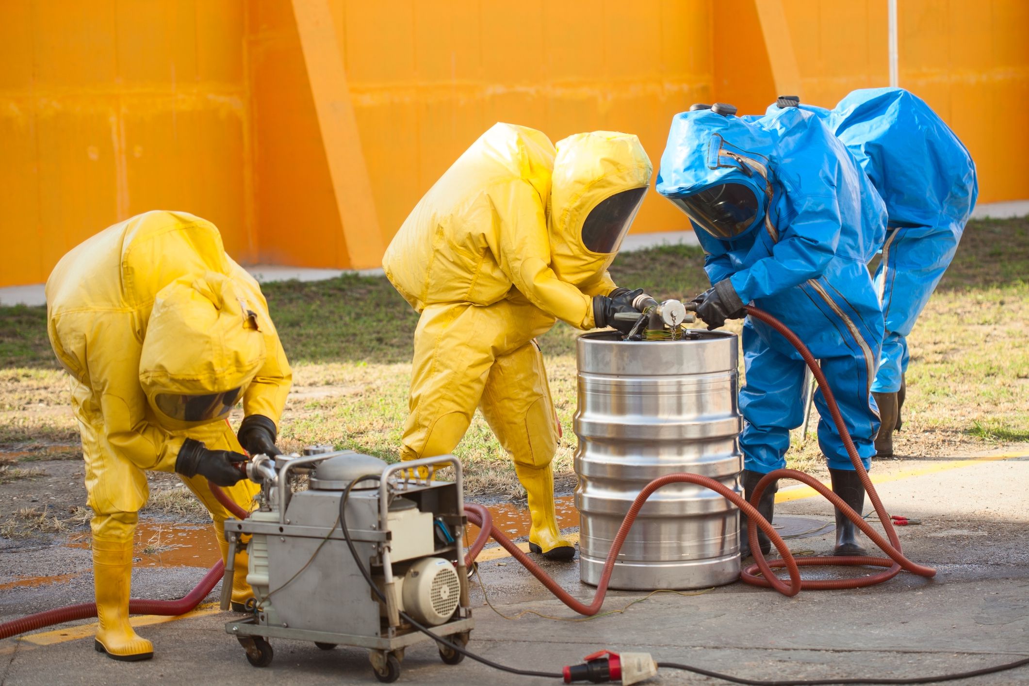 HAZMAT team, coolecting dangerous materials, working with pump.