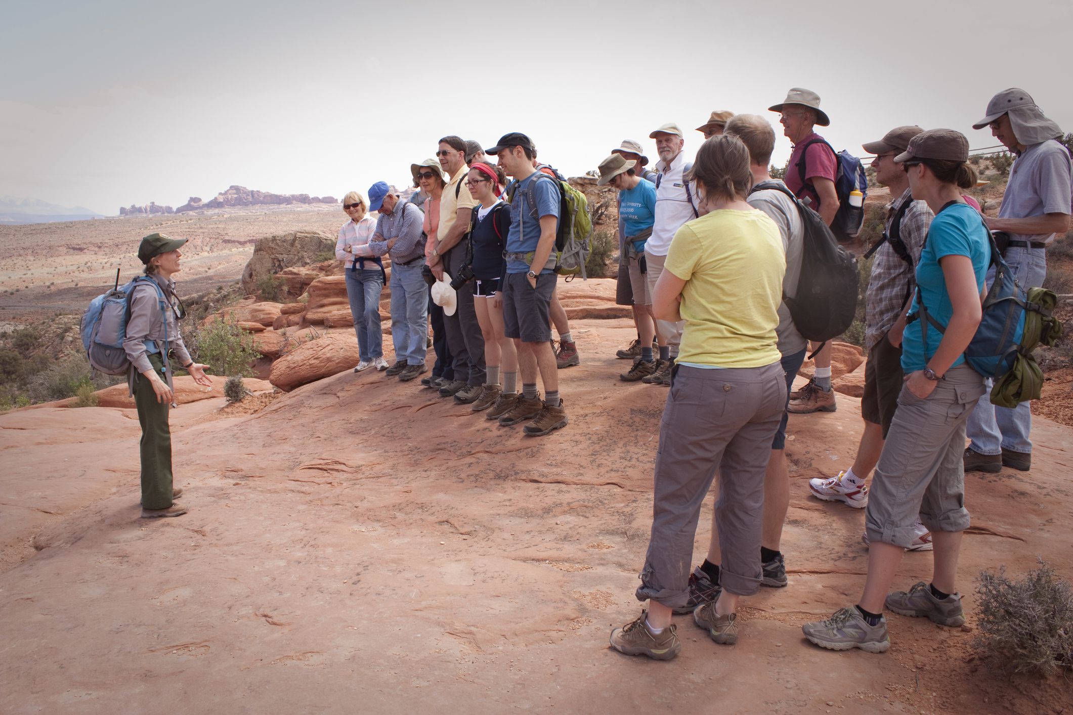 Moab, Utah, USA - April 26, 2012: A Park Ranger talks to a group of people before leading them on a hike through the