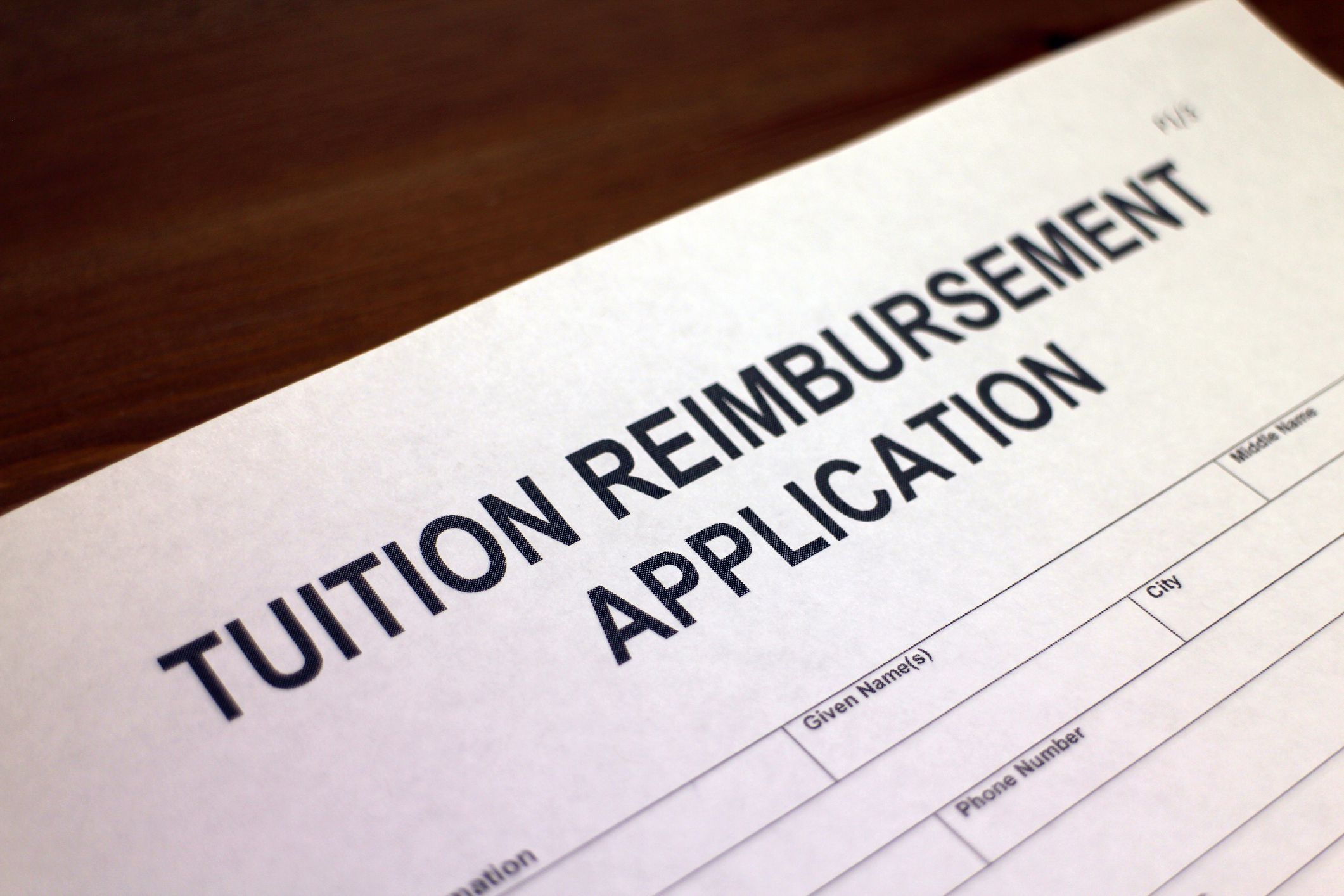 Someone filling out Tuition Reimbursement Application form