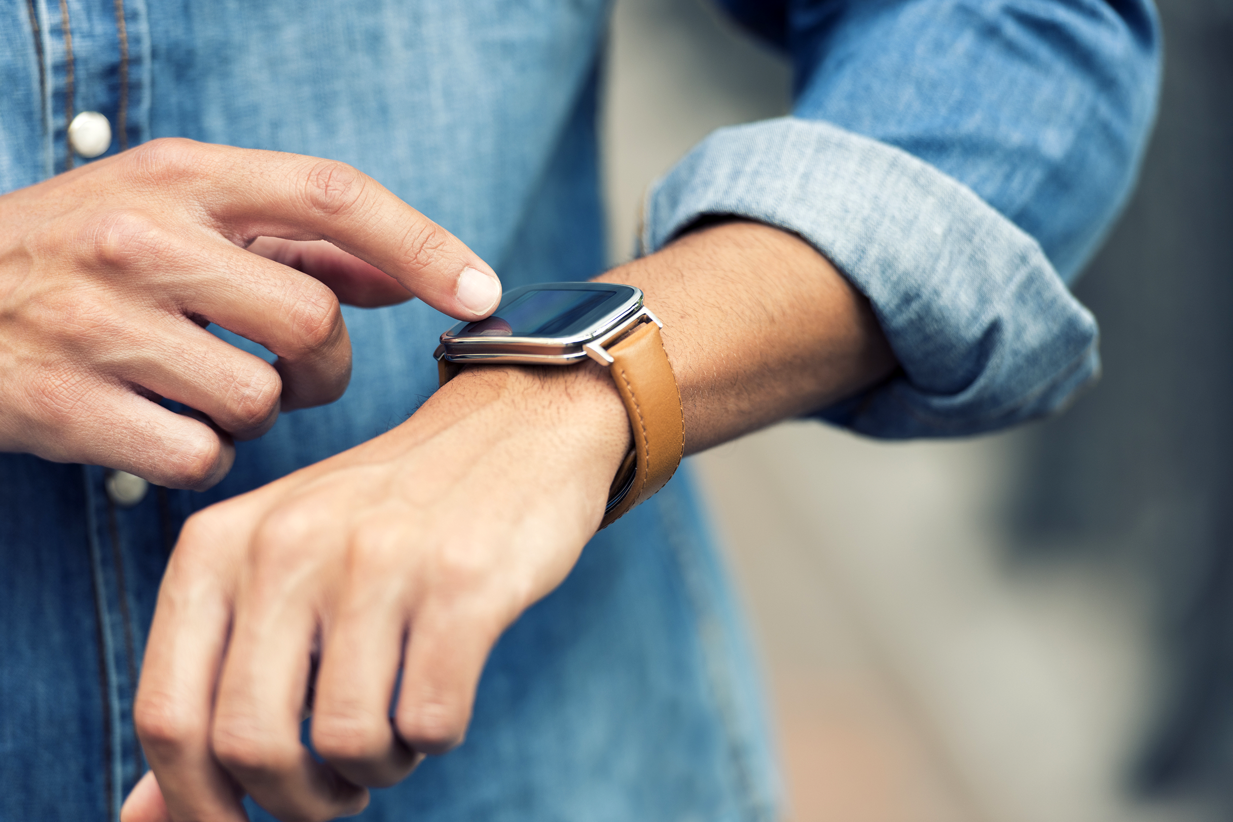 Man looking at this wrist watch