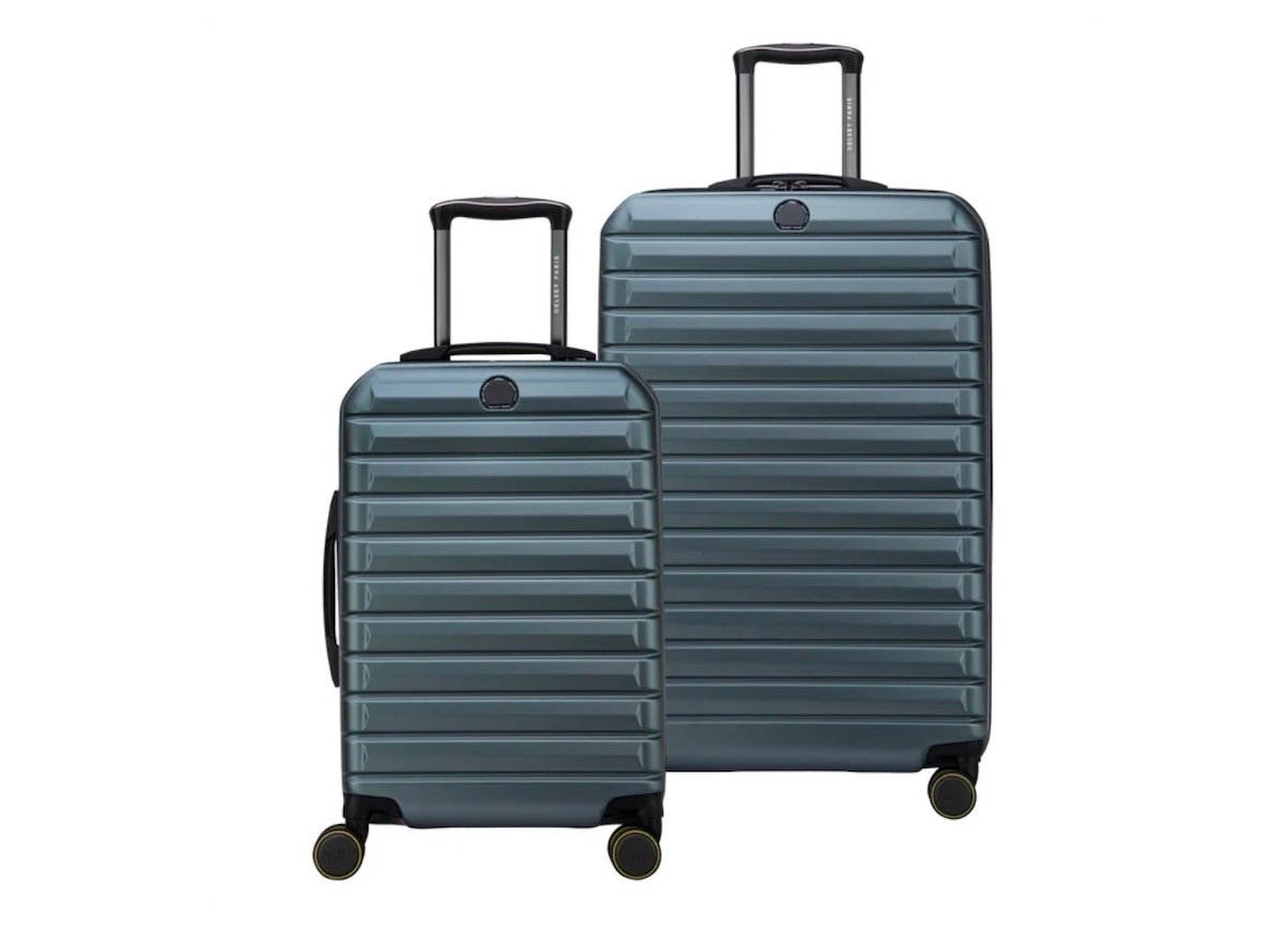 Two hard-shell suitcases, one large and one small, both in metallic blue with horizontal ridges, black handles, and four wheels, stand side by side against a white background—perfect for travelers seeking Costco deals for seniors.
