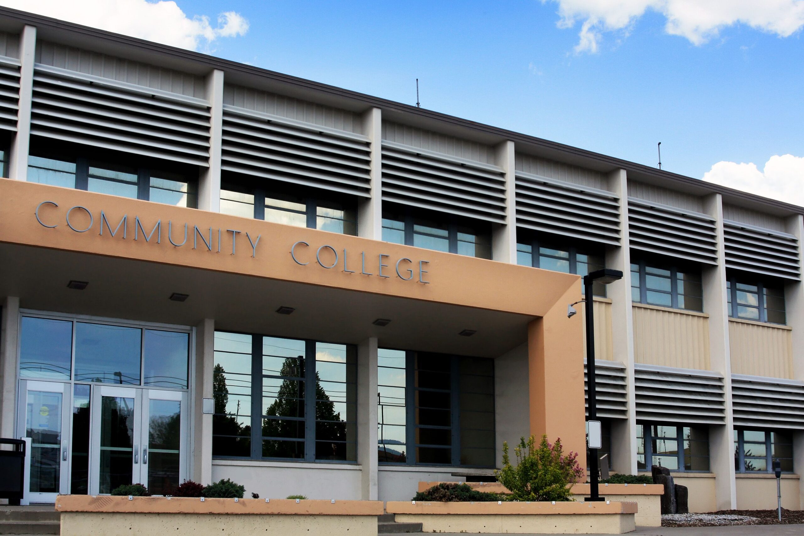 Entrance to a community college building during a sunny, spring day