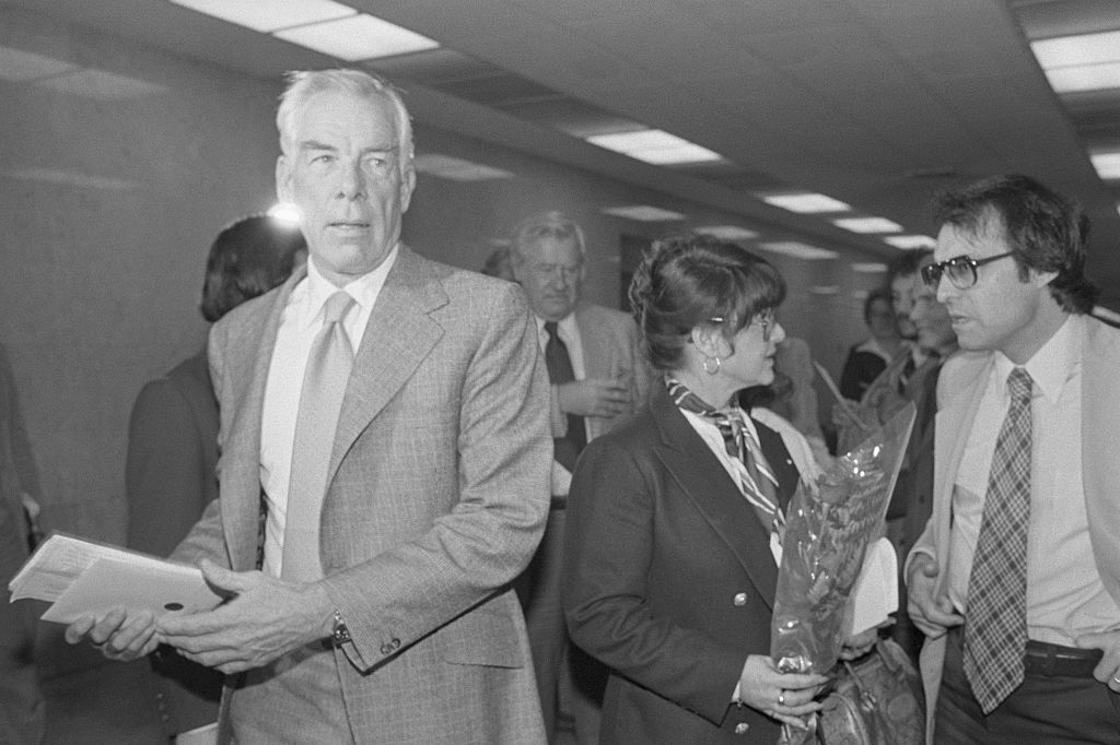 Michelle Triola Marvin, (R) holding a single rose is ignored by her former lover, Lee Marvin, as they return to Superior Court after a lunch break. The judge at the trial rejected an attempt by his mistress to seek $1 million in punitive damages for fraud