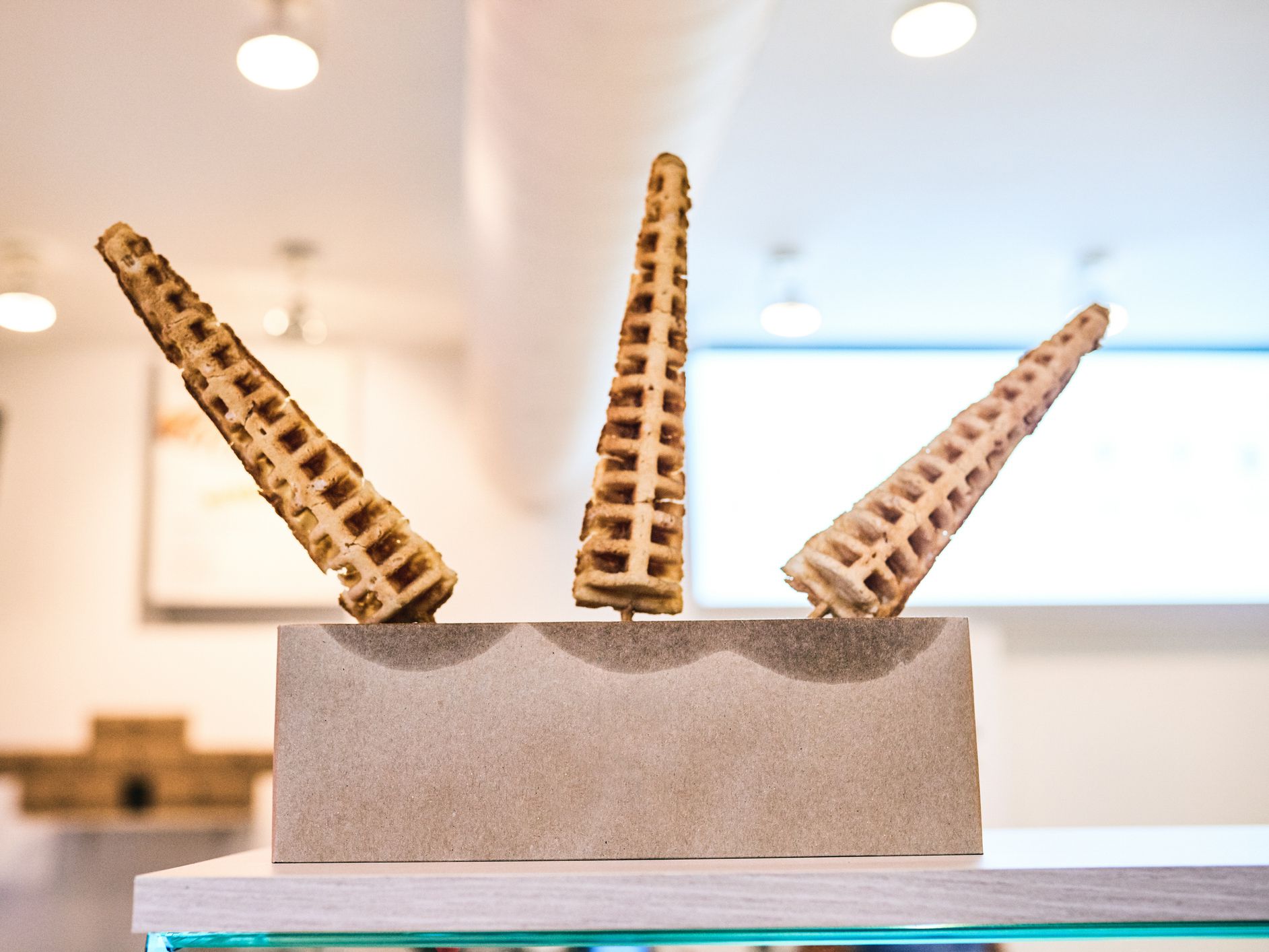 Shot of waffles in the shape of a cone on a display stand at an ice cream parlour