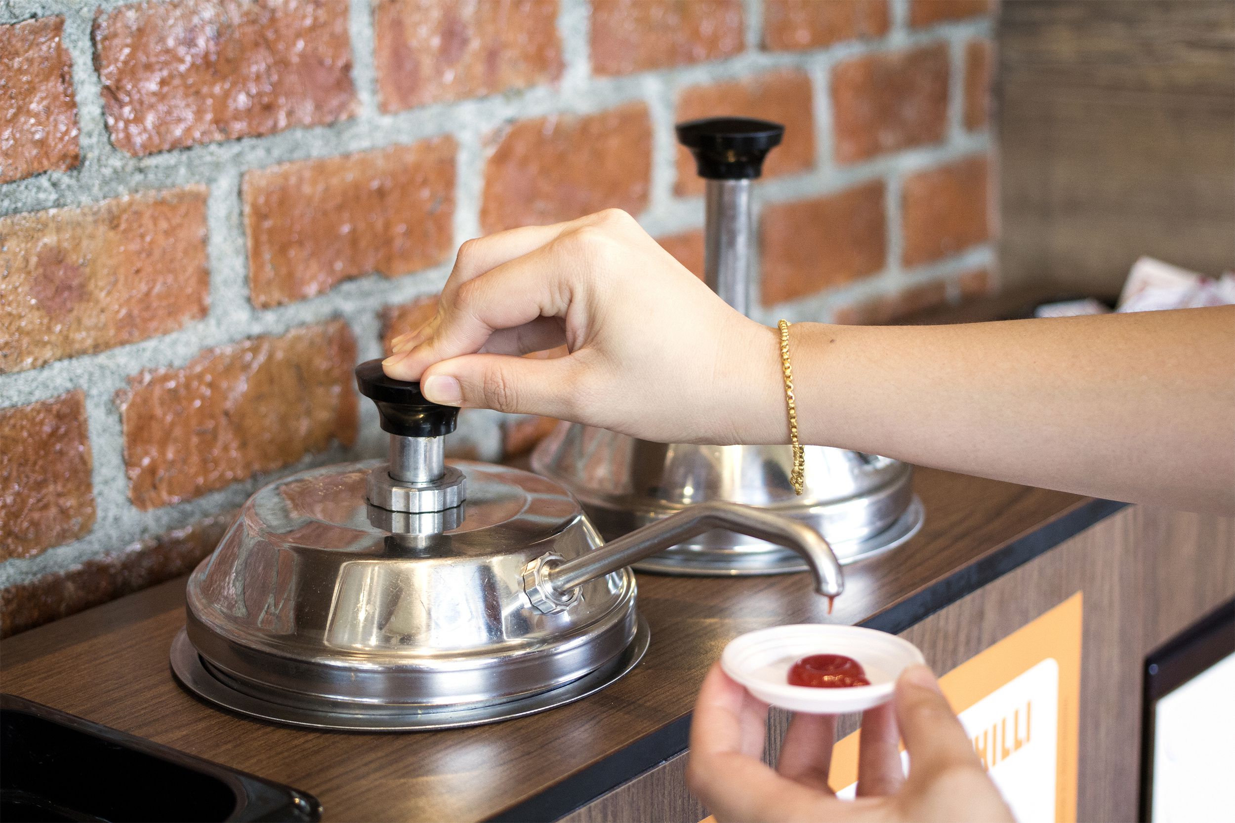 Woman pumping ketchup