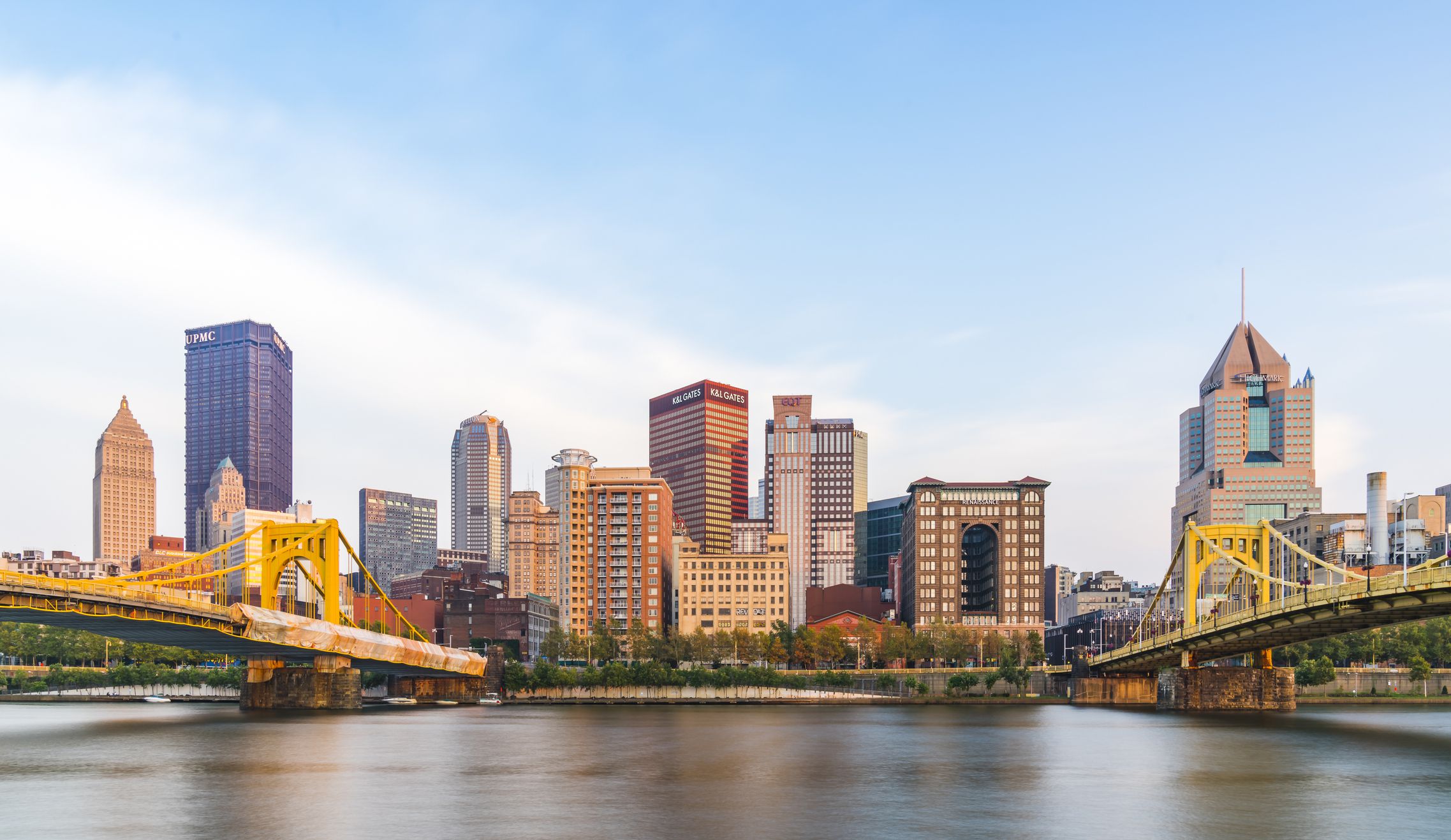 pittsburgh skyline at sunset with reflection in the water.