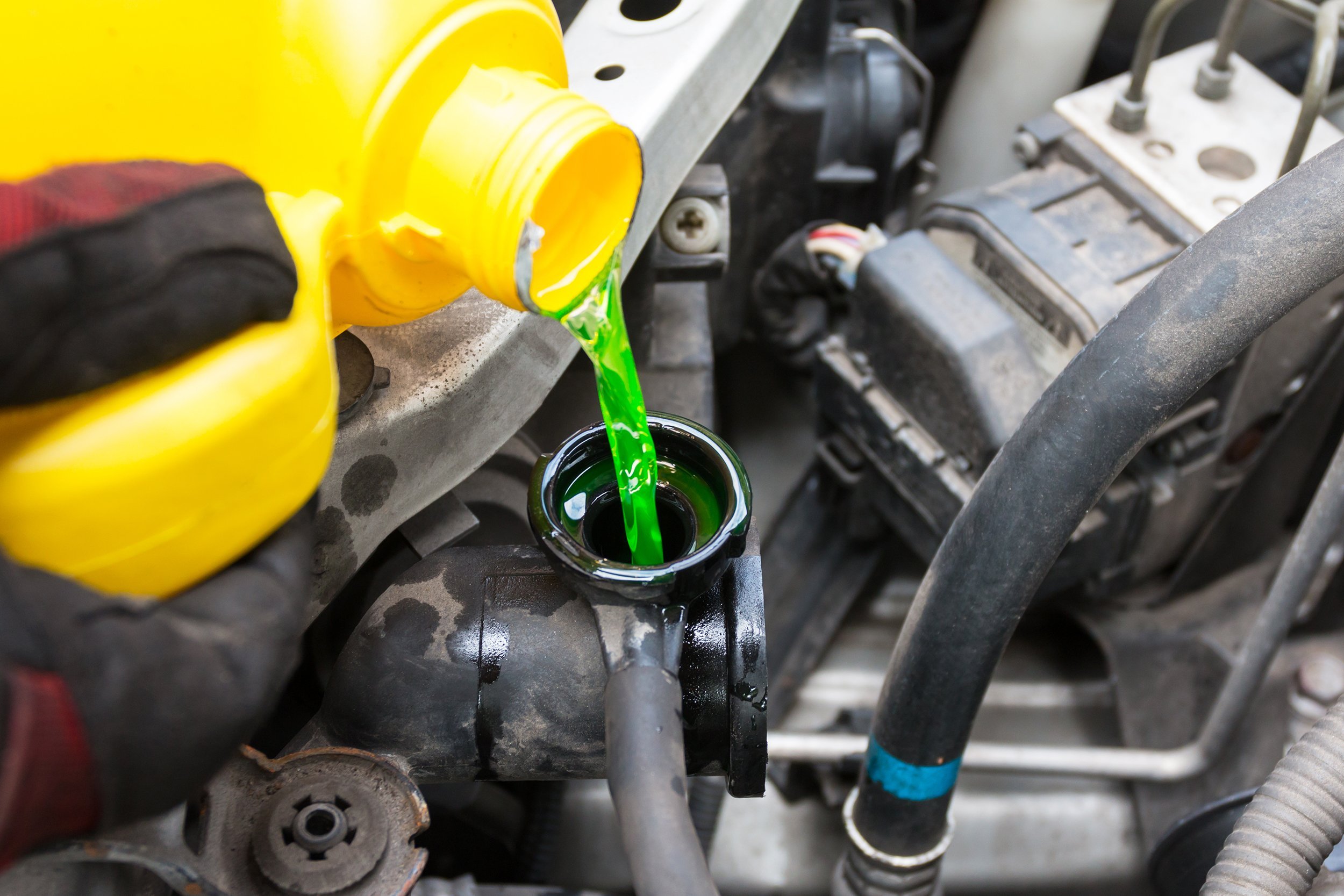 hand pouring coolant
