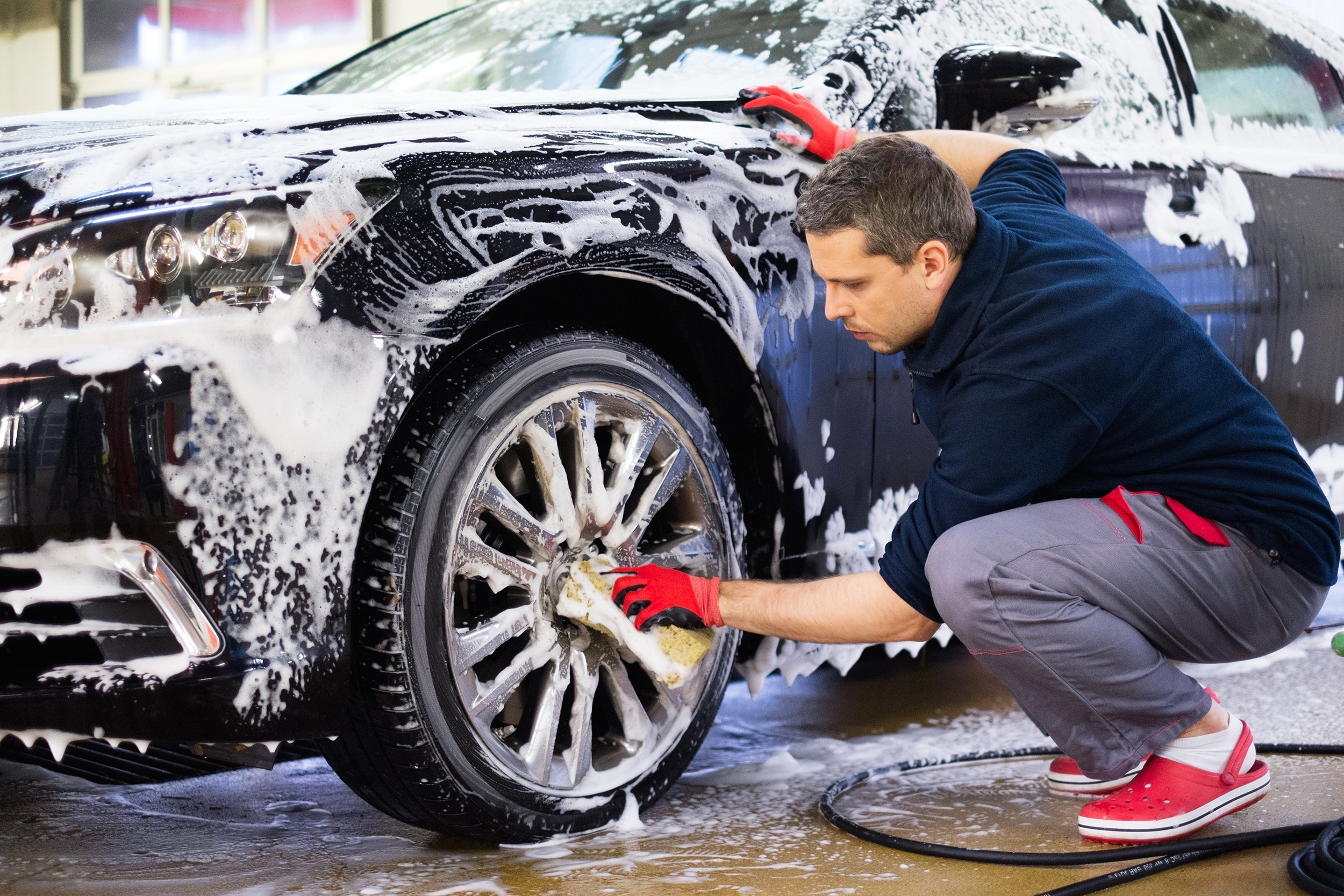 man washing his car