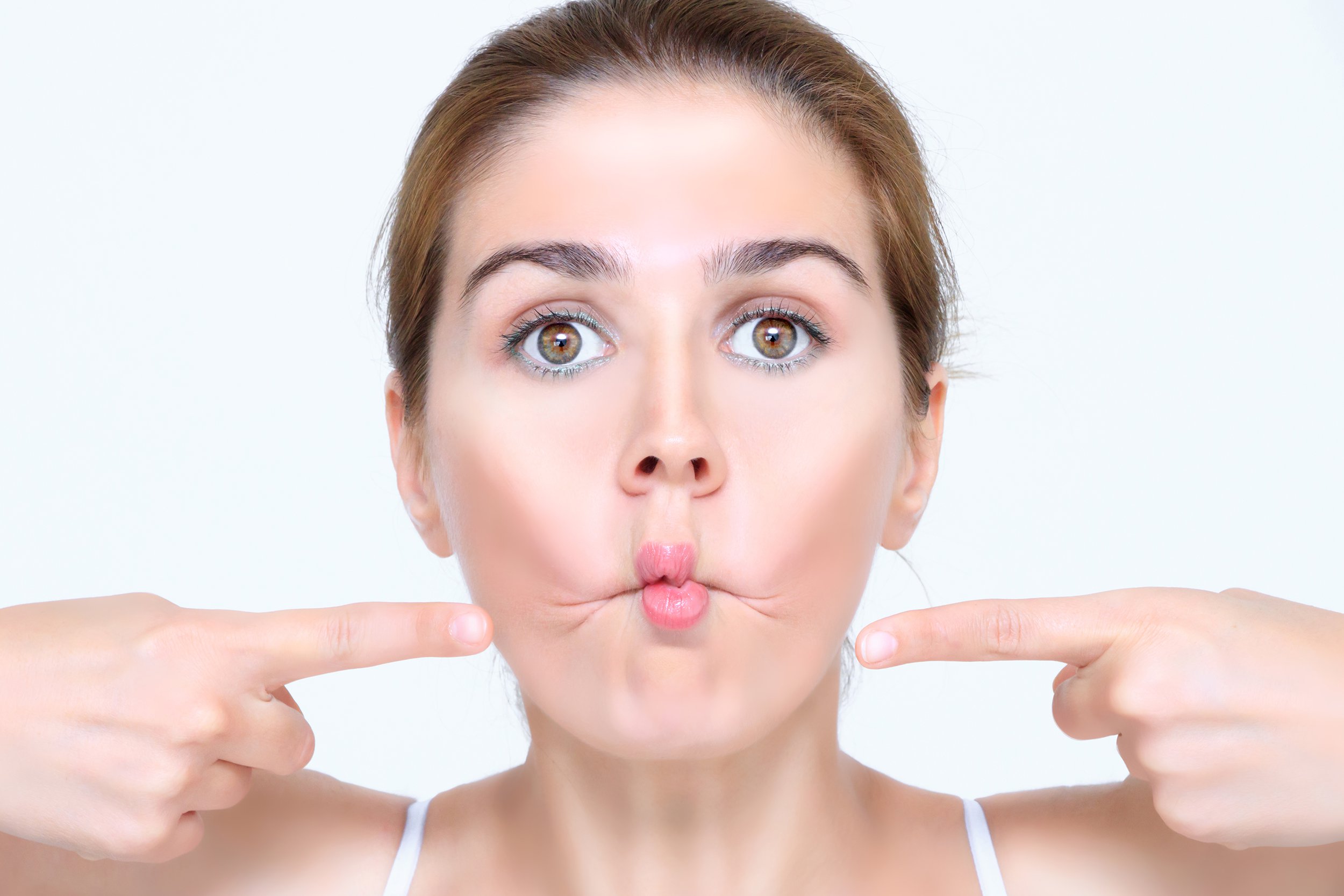 young woman doing facial yoga