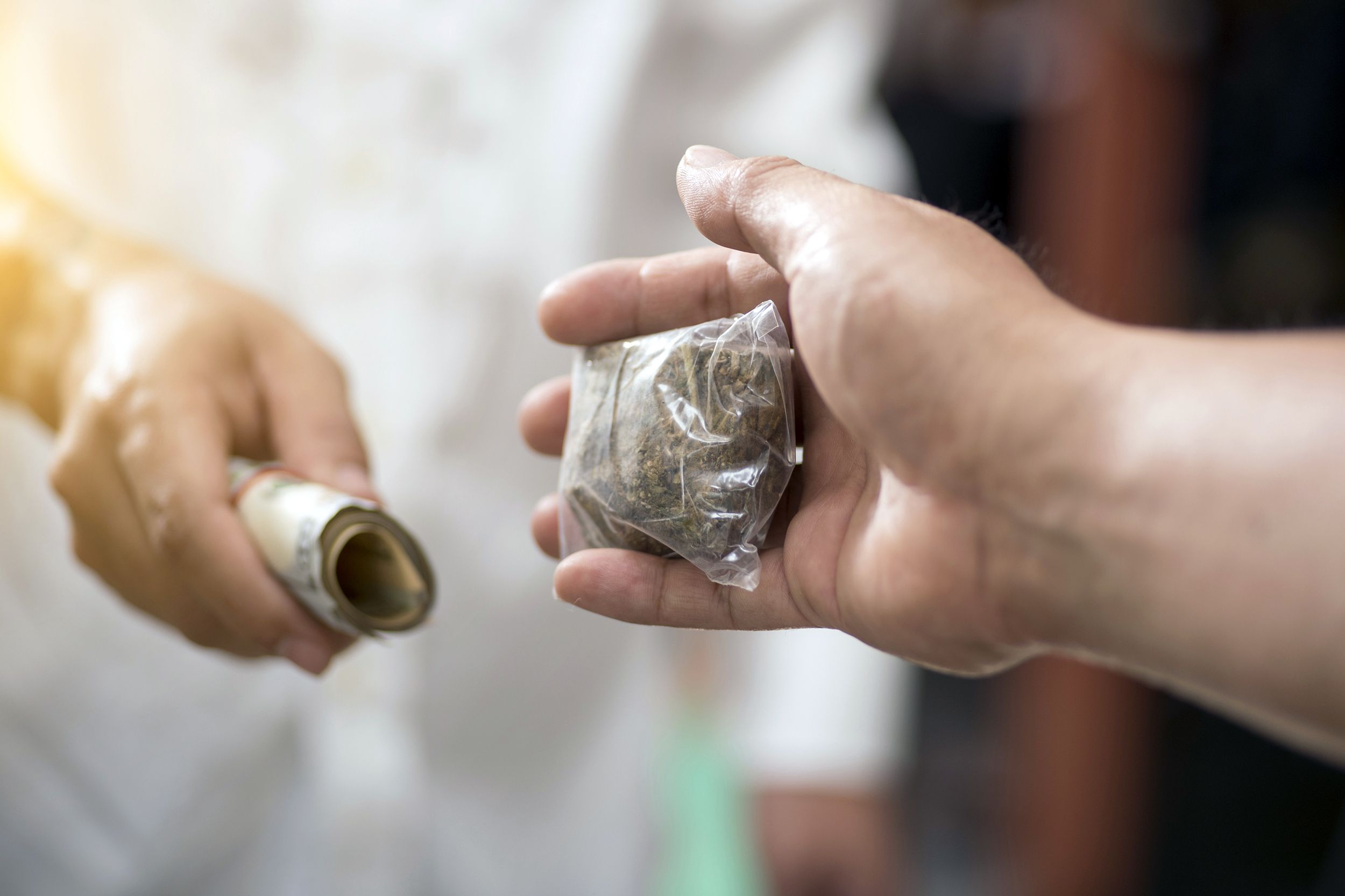 person buying cannabis and paying