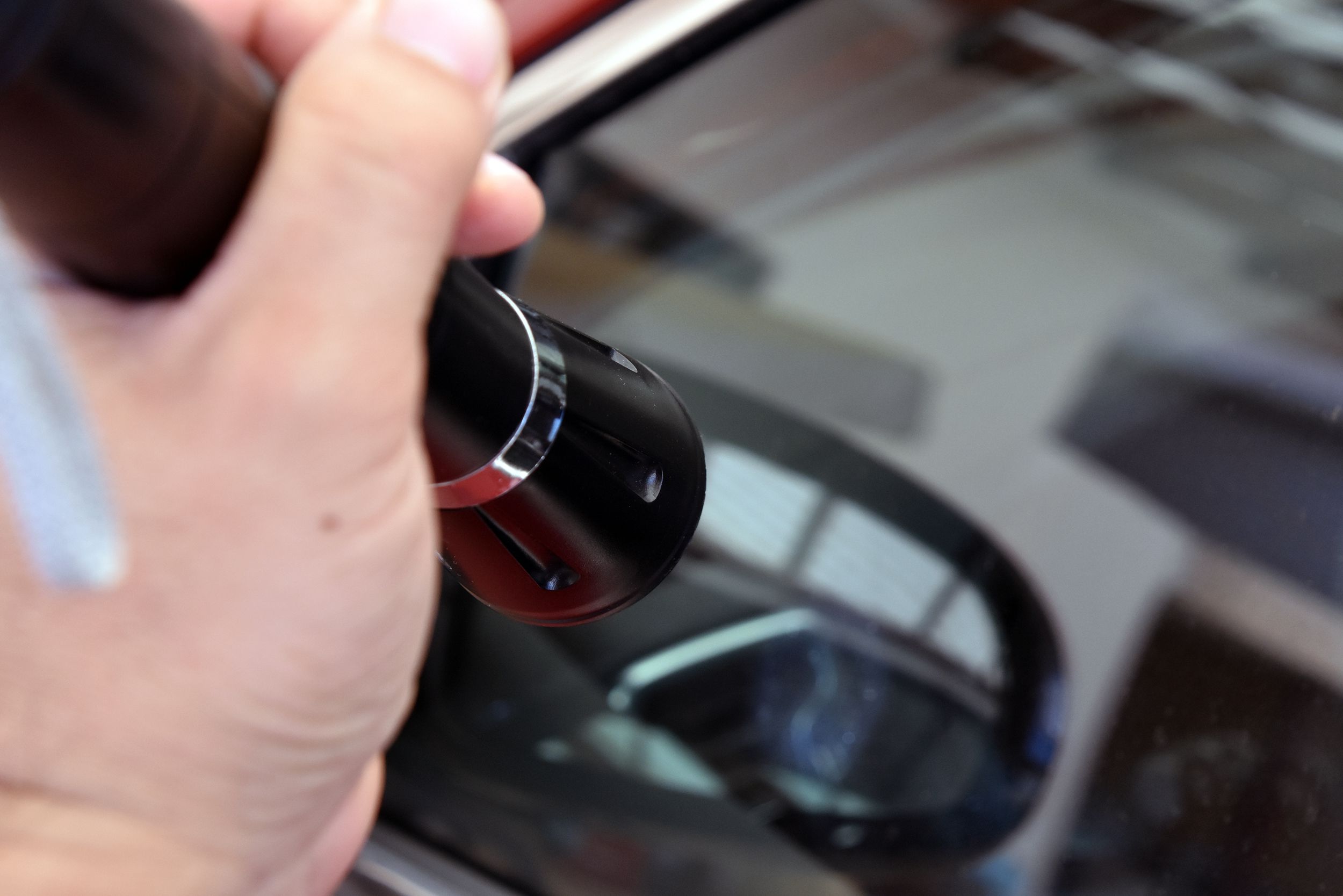 police with flashlight looking into car